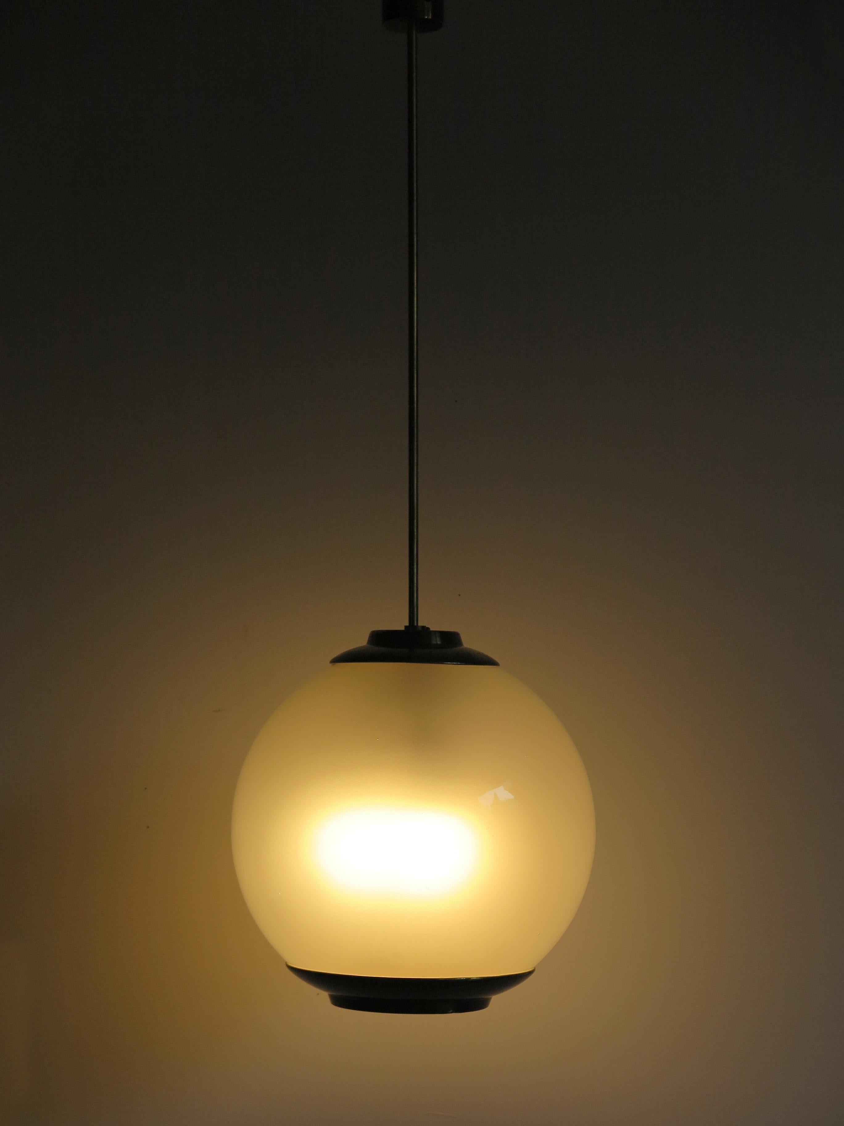 Italian Mid-Century Modern design pendant lamp model “Lanterna LS2” designed by Luigi Caccia Dominioni and produced by Azucena with opal glass sphere diffuser and brass details, 1950s.