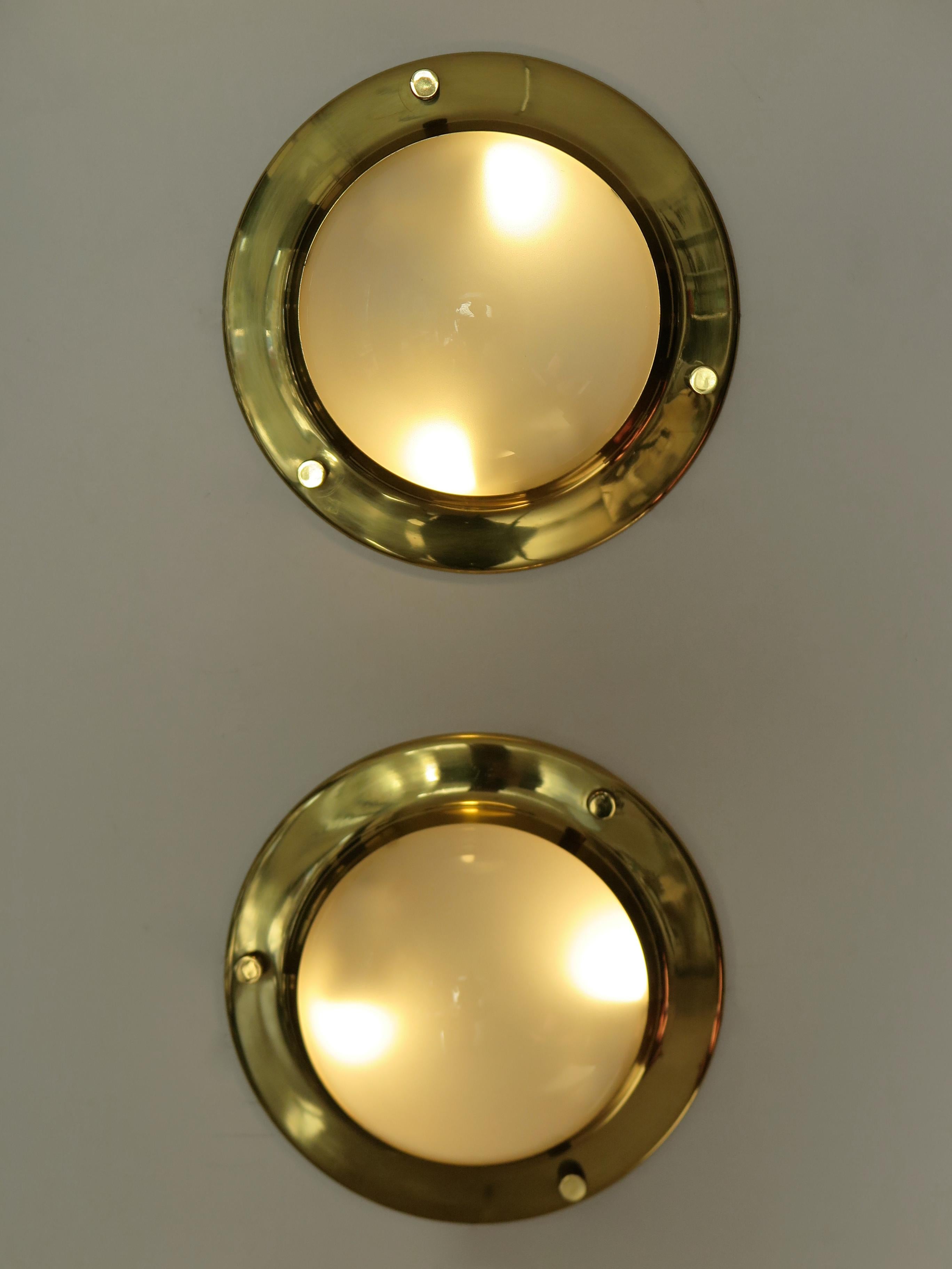 Italian midcentury modern design set of two scones wall lamps or ceiling lamps model “LSP6 Tommy” designed by Luigi Caccia Dominioni (Milan 1913 - Milan 2016) and produced by Azucena from 1965 with polished brass frame and half-sphere diffusers made