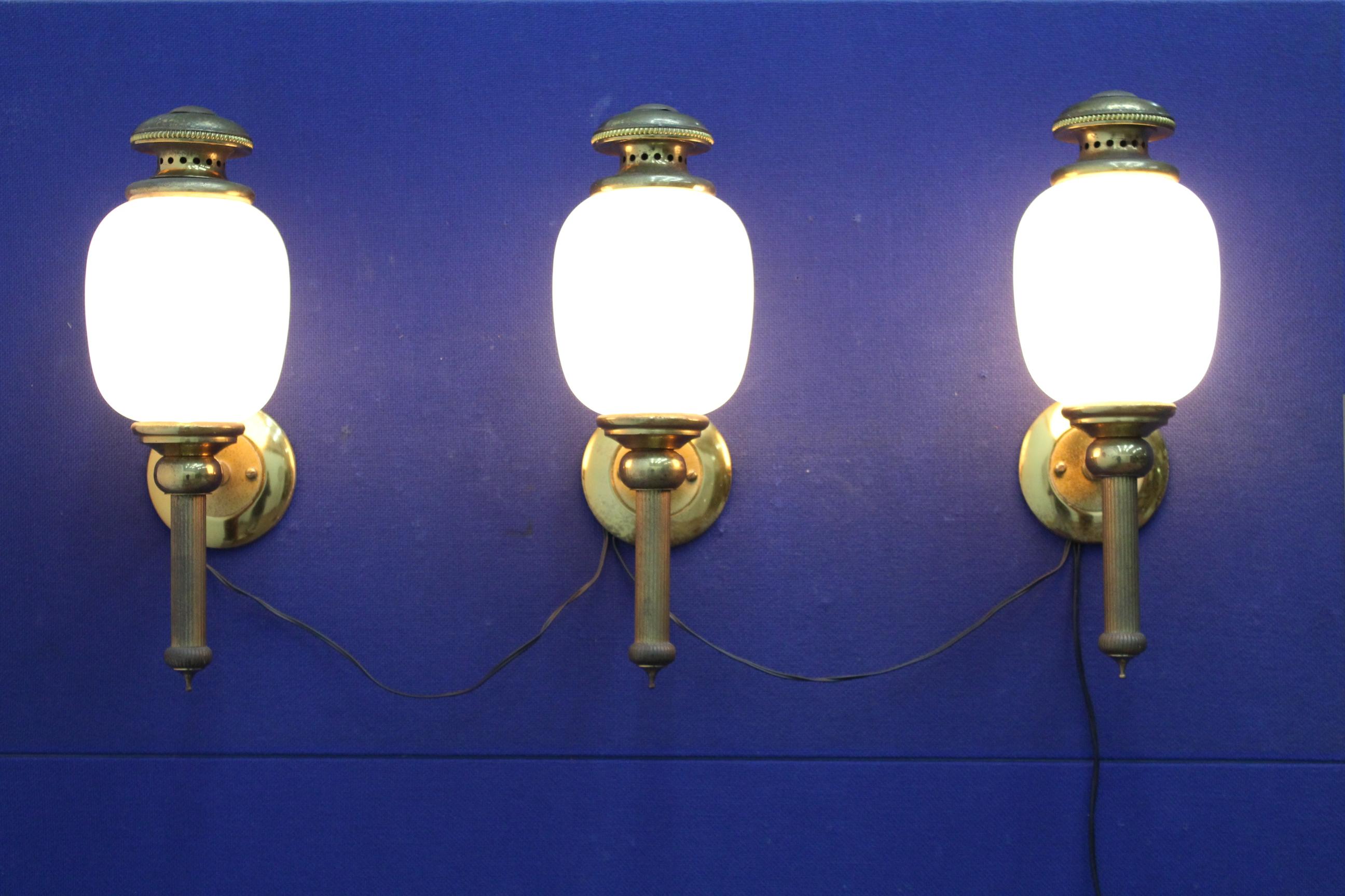 An original set of 1950s Italian polished brass and opaline glass globes wall lights by Sciolari Roma 1950s, set of 3.
