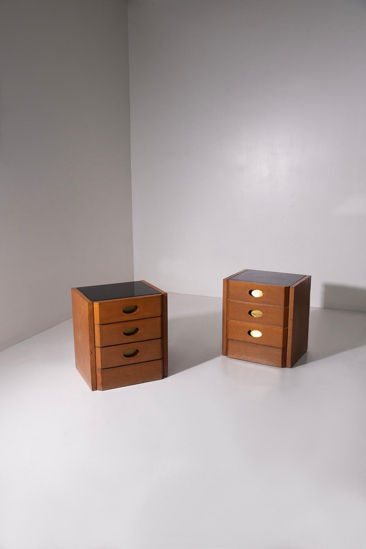An exceptional and rare pair of 1950s bedside tables designed by the renowned architect Luigi Caccia Dominioni, a pivotal figure in Italian modernist design. These nightstands, crafted from high-quality walnut wood, are a testament to the