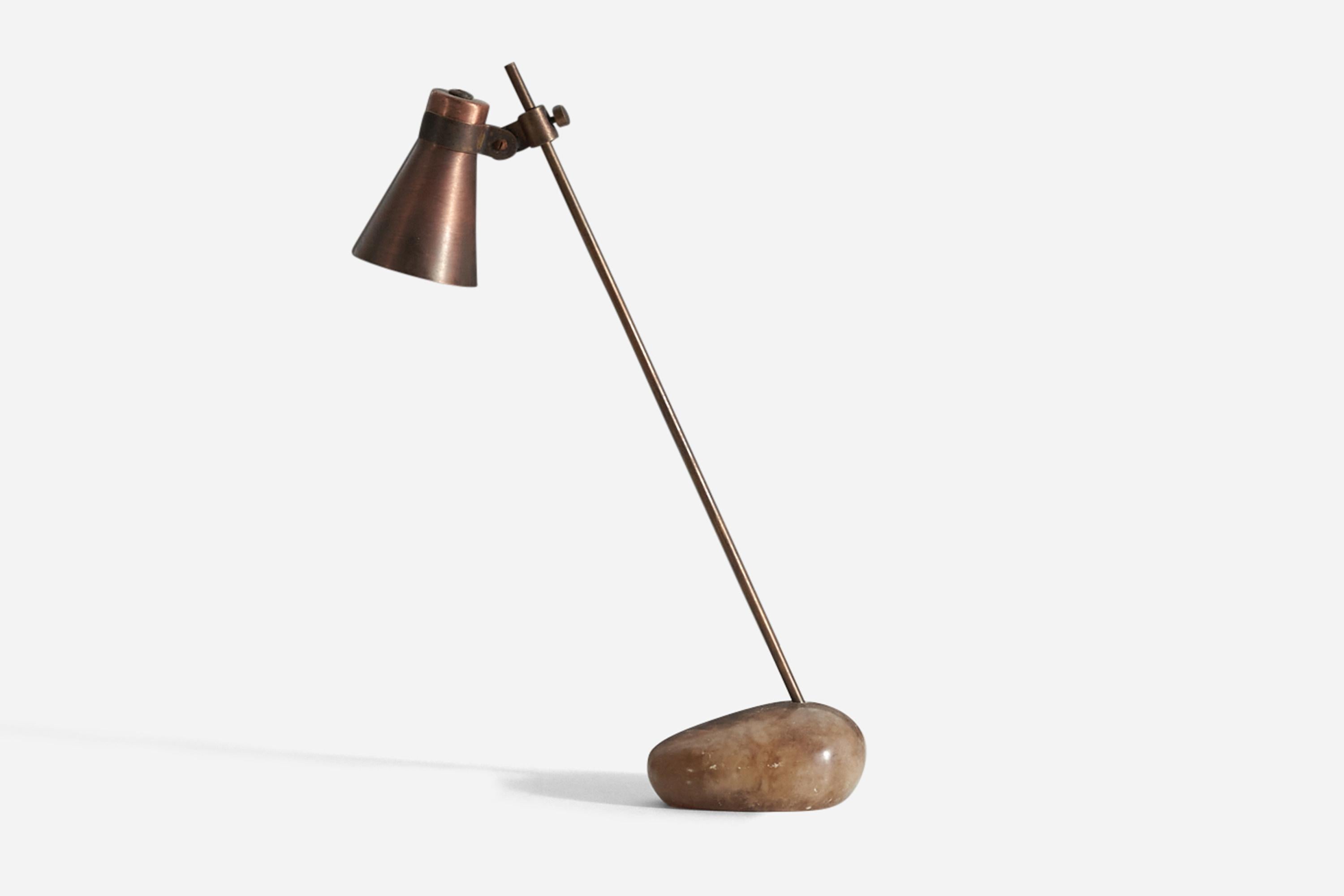 A rare and early ‘Sasso’ table lamp designed by Luigi Caccia Dominioni and produced by Azucena, Milan, Italy, c. 1948. The lamp is composed of a brass stem standing in a polished Iranian river stone base, with a lacquered brass metal lampshade.
 