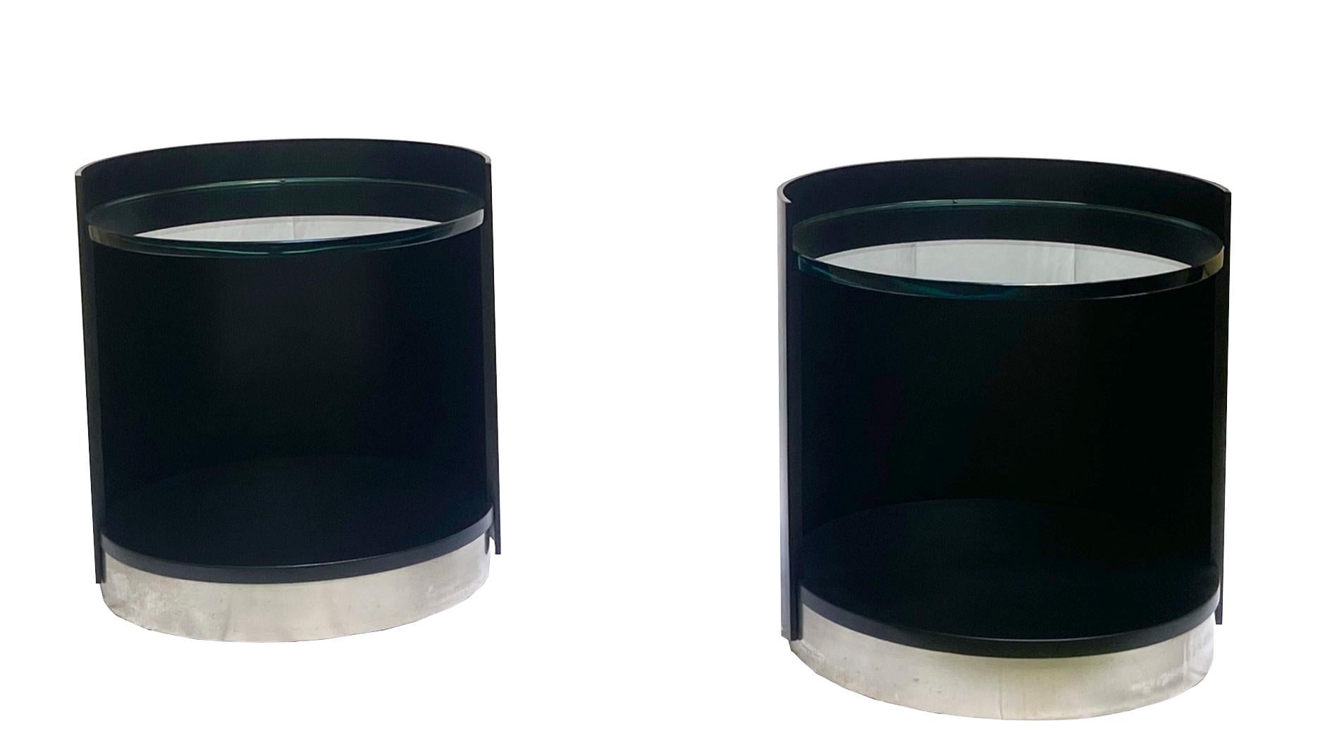 Pair of side tables, wood, glass and metal, Italy, 1970s.

Pair of nightstands in the style of Luigi Caccia Dominioni. 
The tables have a cylindrical shape, featuring a black lacquered wood frame that's open on one side. 
The top consists of a