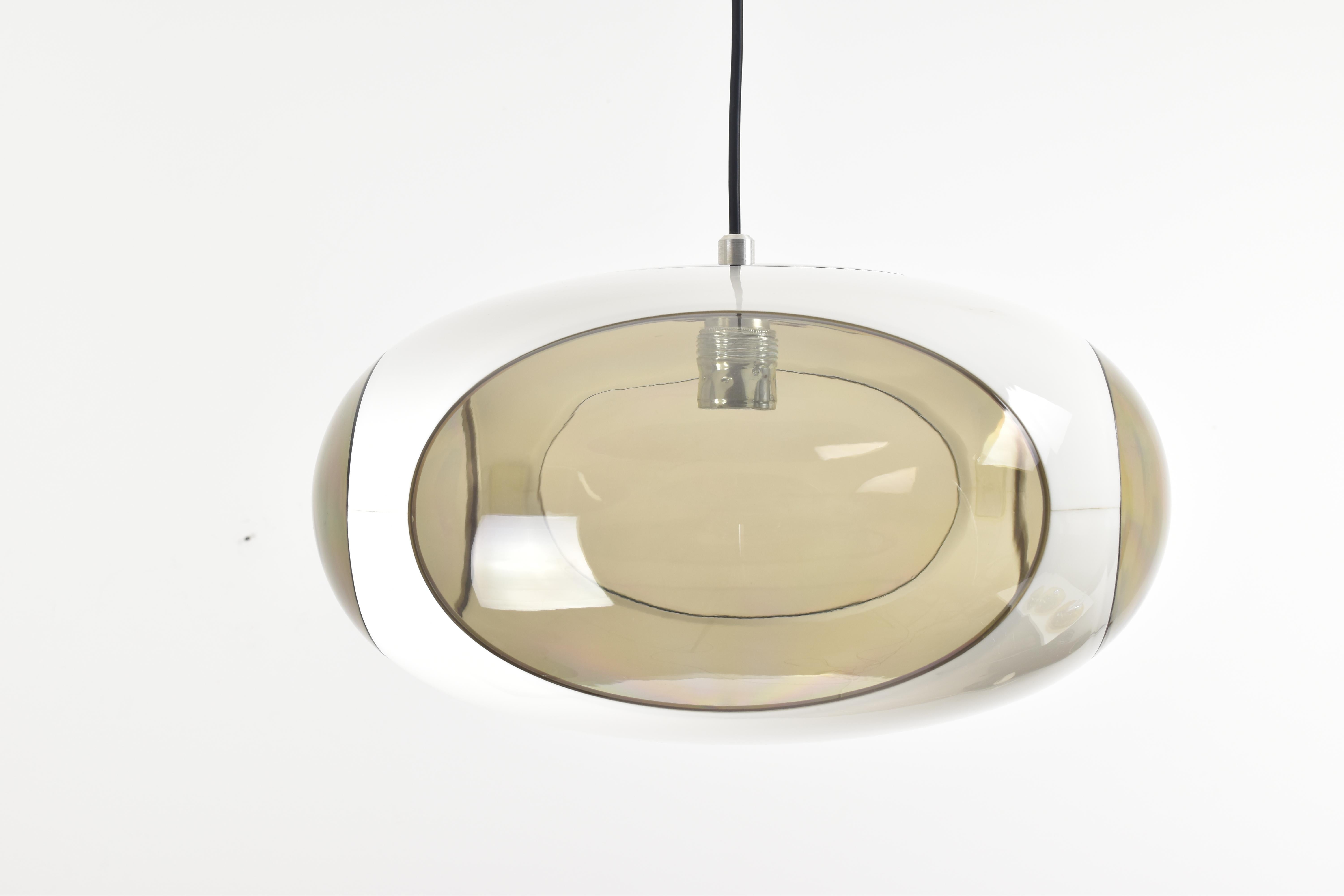 The vintage white UFO pendant lamp, designed by Luigi Colani for Massive Belgium, is a striking and iconic piece of lighting design that reflects both the innovative creativity of the designer and the quality craftsmanship associated with the