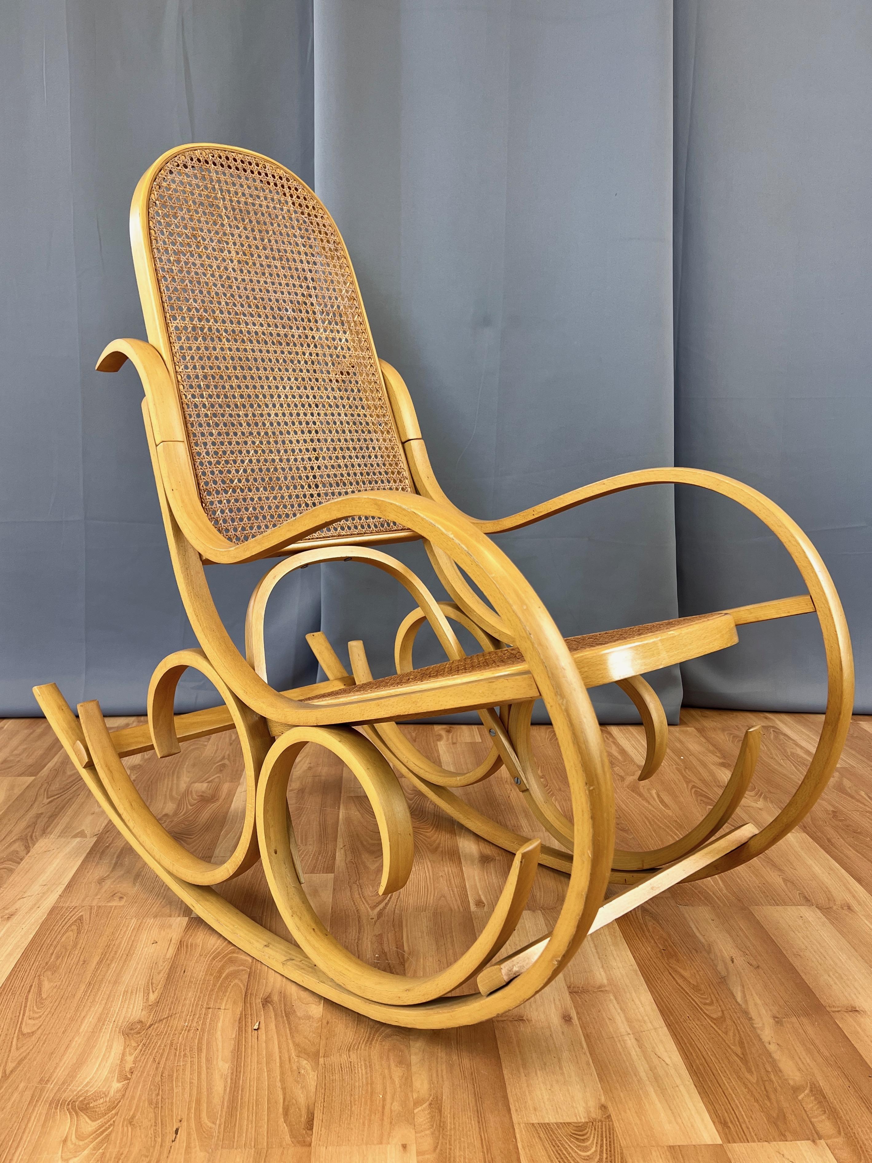 A fantastic 1970s Italian bentwood and woven cane rocking chair by Luigi Crassevig.

Visually striking and perfectly proportioned frame features elegantly hand-crafted blonde bentwood curves, filigrees, and flourishes. Calls to mind similar