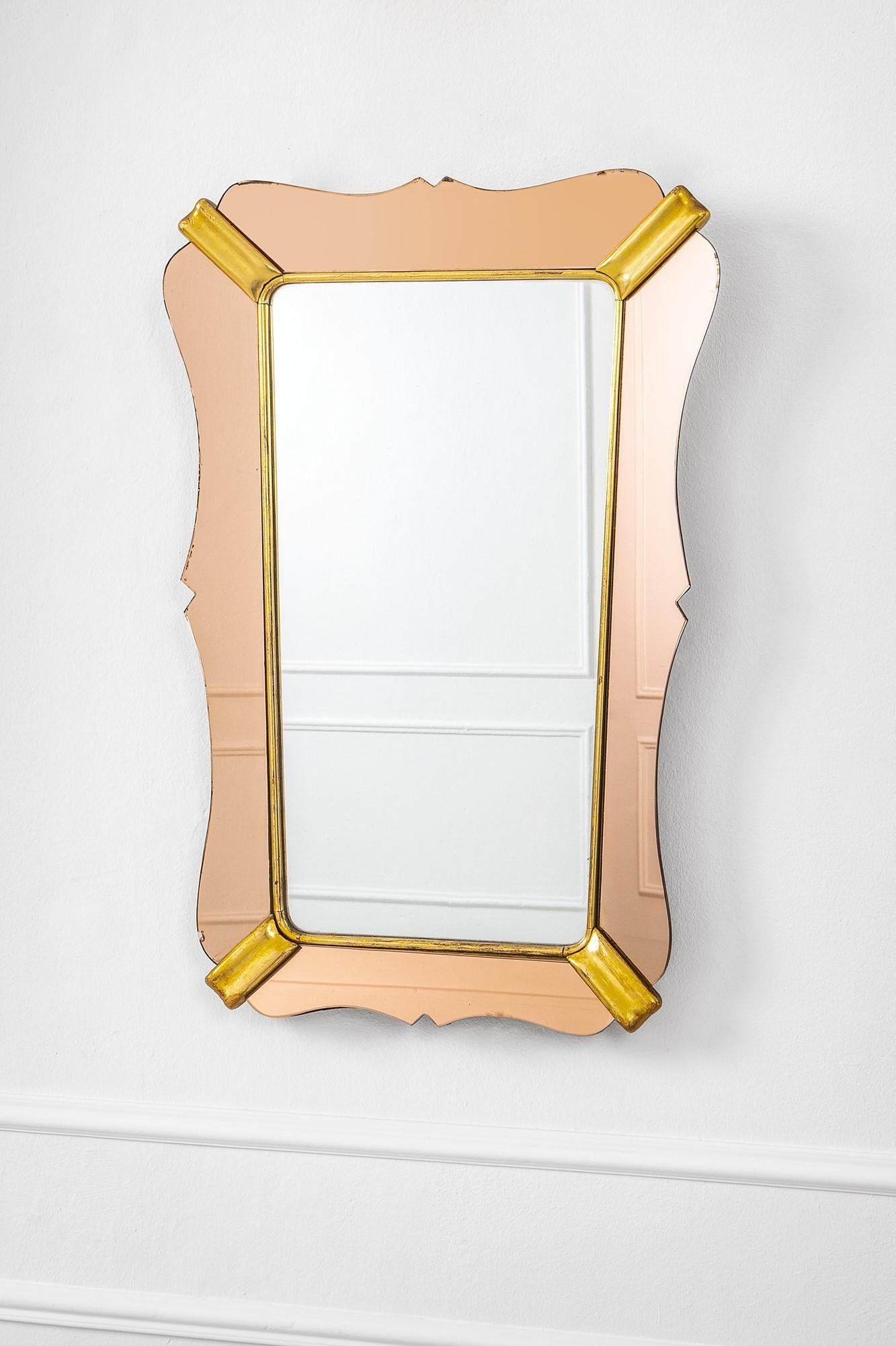 Rare Luigi Fontana mirror. Mirrored rose glass and gilded wood. Italy, 1950s.
