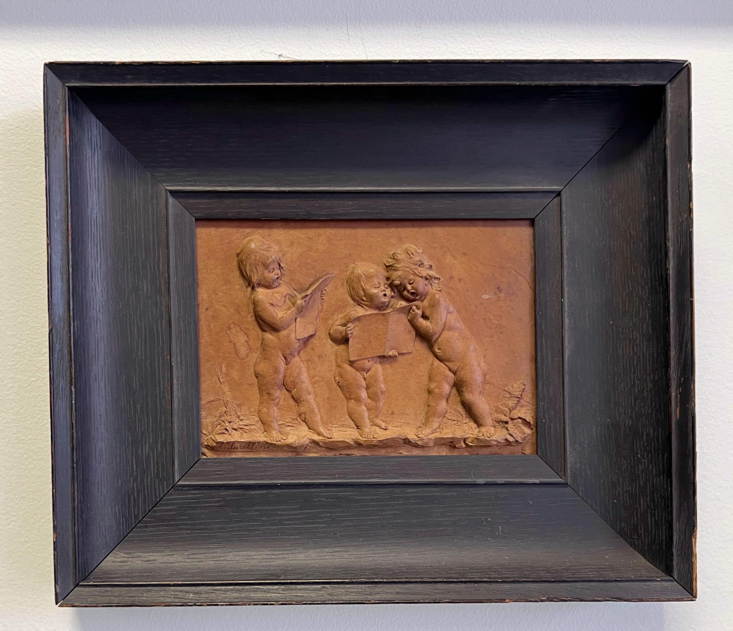 A rare carving by Luigi Frullini depicting 3 young figures reading. Very fine detail done in virtuoso technique. Signed and framed on n ebonized oak period frame from Anderson Art Co. Chicago. 
The plaque itself is 7” by 4.75”