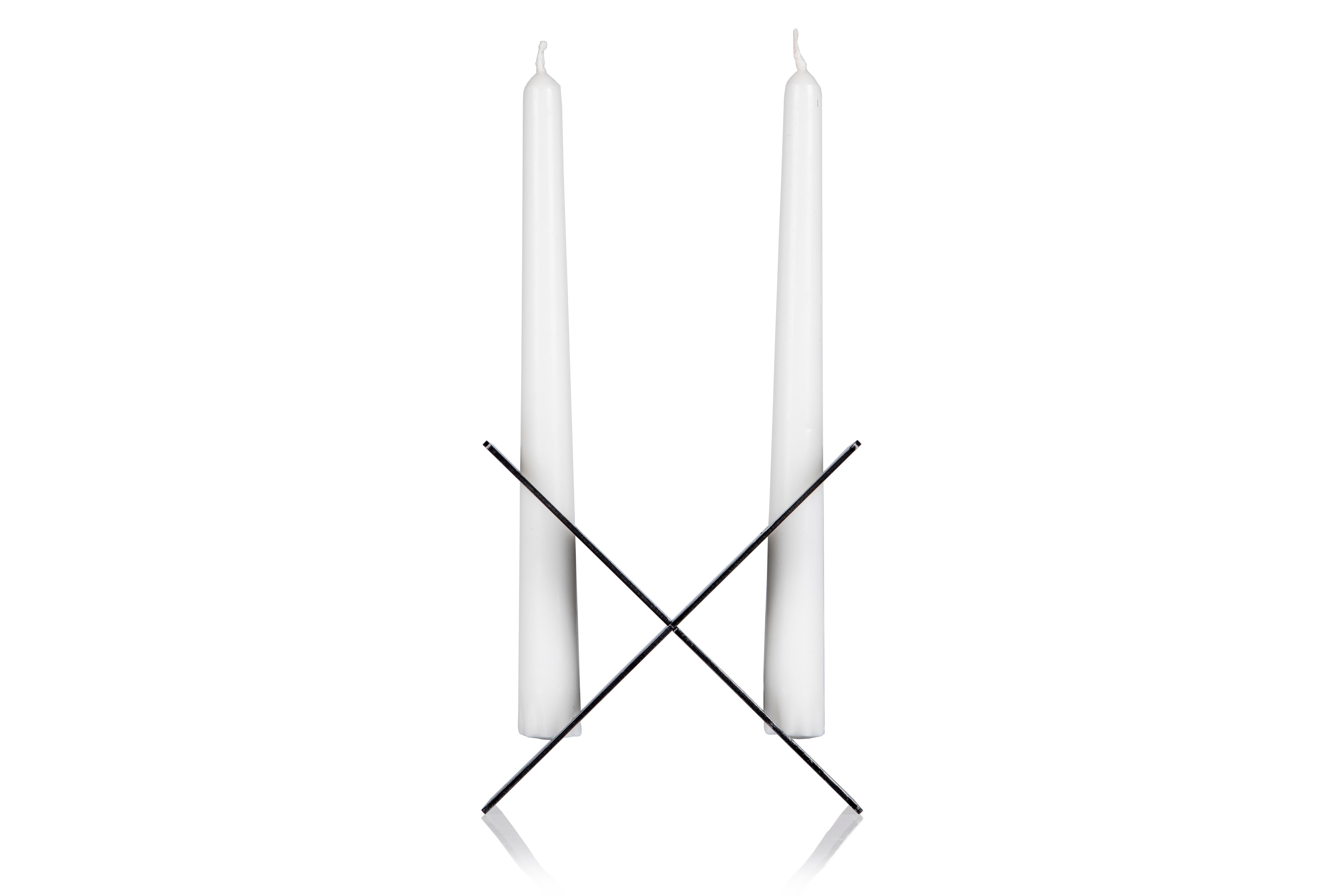 Luigi is a two-armed candleholder, made with two pre-drilled plates in iron, which joined together to create a cross-shaped structure to carry two candles.