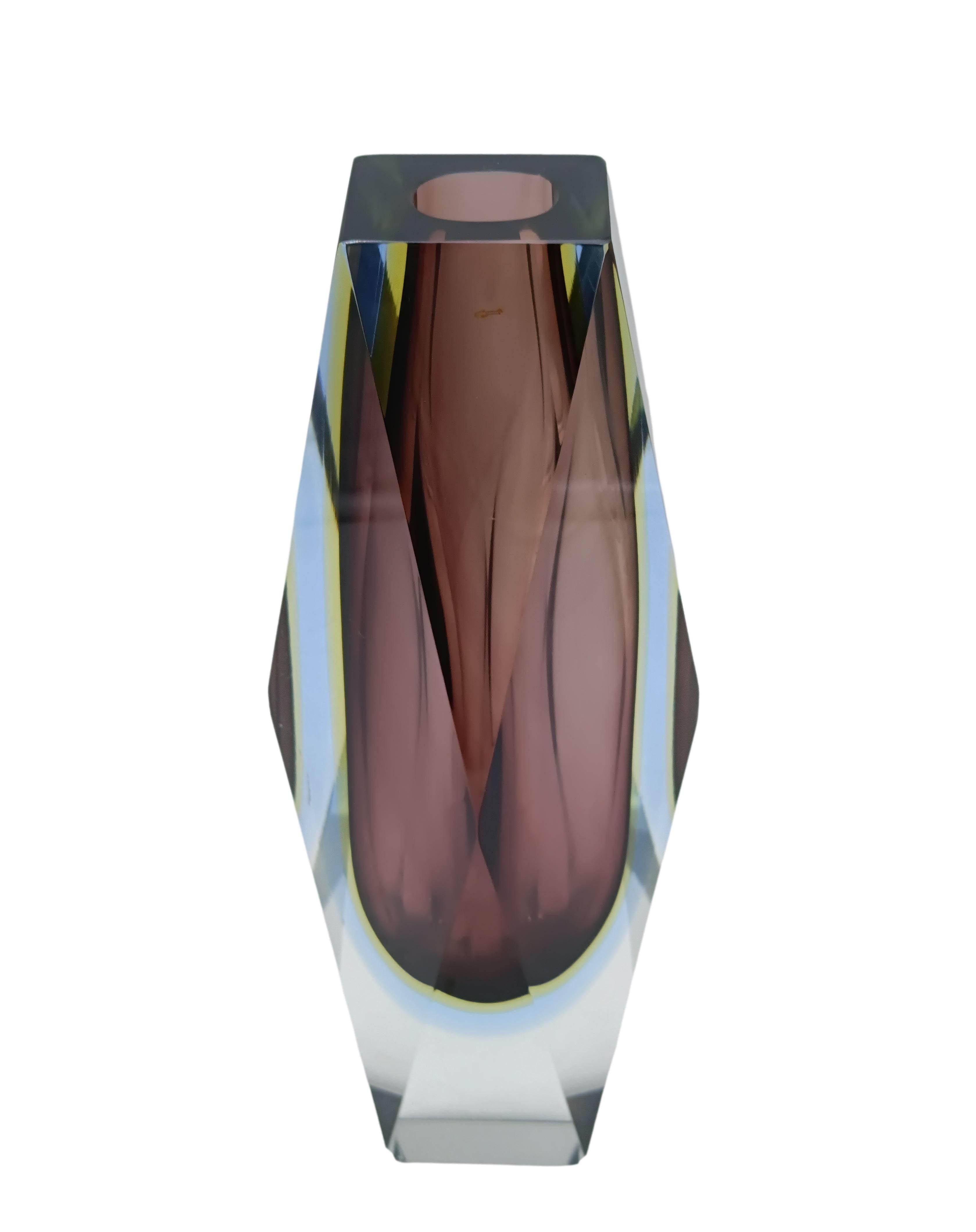 Gorgeous vase  by Luigi Mandruzzato, an icon of Venetian glassmaking, dating back to 1950. With its intense purple tones highlighted by crisp, clear glass, this vase is a perfect example of faceted Murano glass. Designed to capture light and project