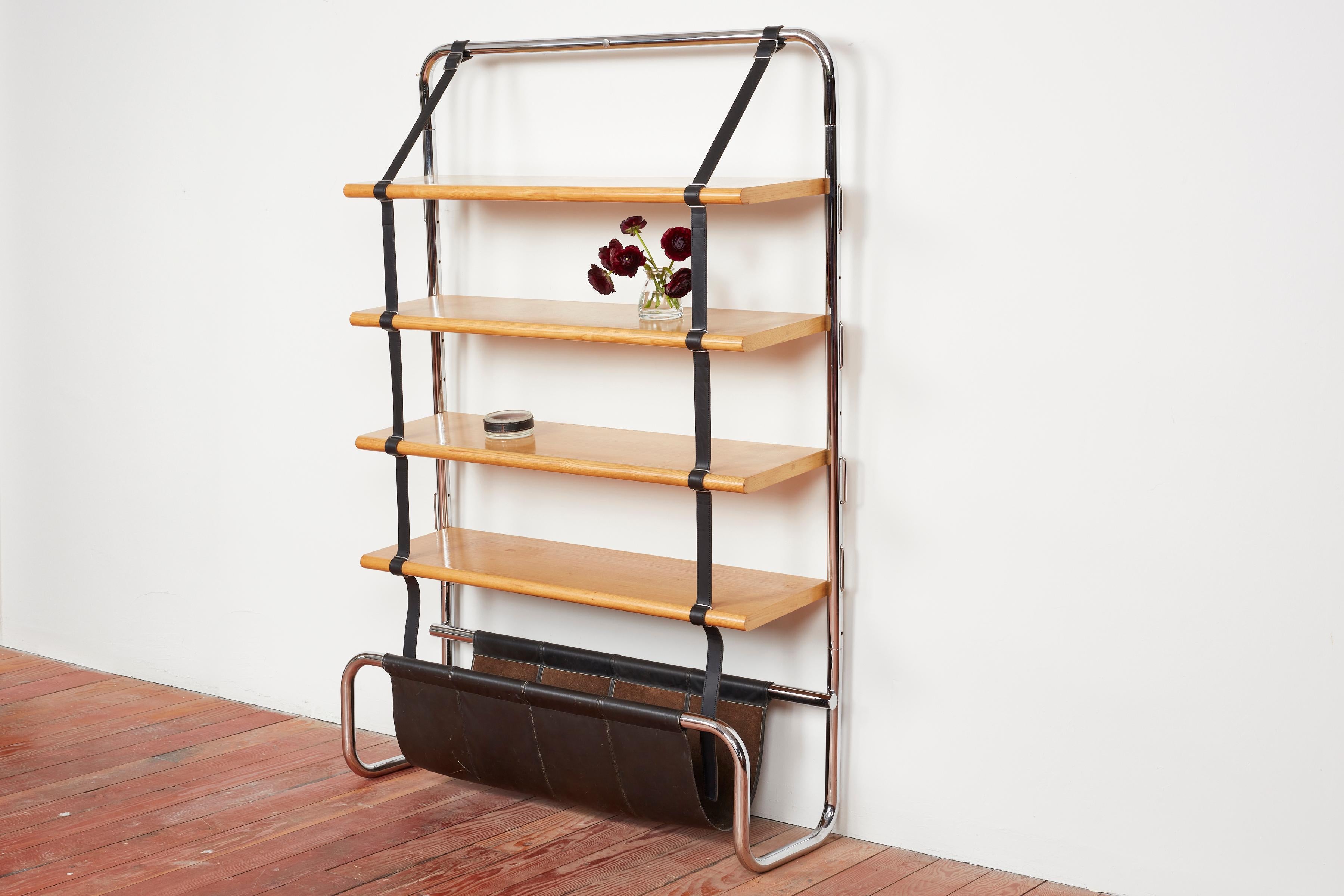 Wonderful bookcase by Luigi Massoni for Poltrona - Italy, circa 1970s

Impressive large scale Italian wall shelf designed by Luigi Massoni for Poltrona Frau, 1971. 
Chromed tubular steel frame with natural wood shelves suspended by black leather