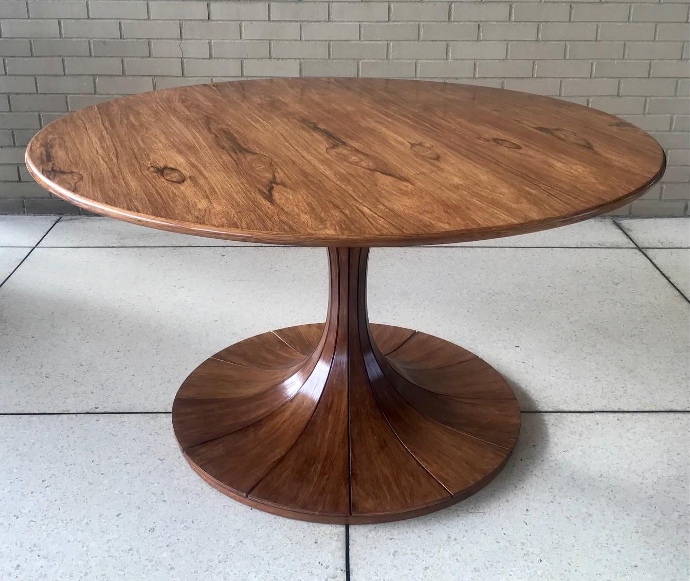 Luigi Massoni, one of the giants of Italian design, offers us this exquisitly figured dining or centre table. It looks great when solo in a space or with chairs around. This table has a number of variants, with different woods and pedestal shapes.
