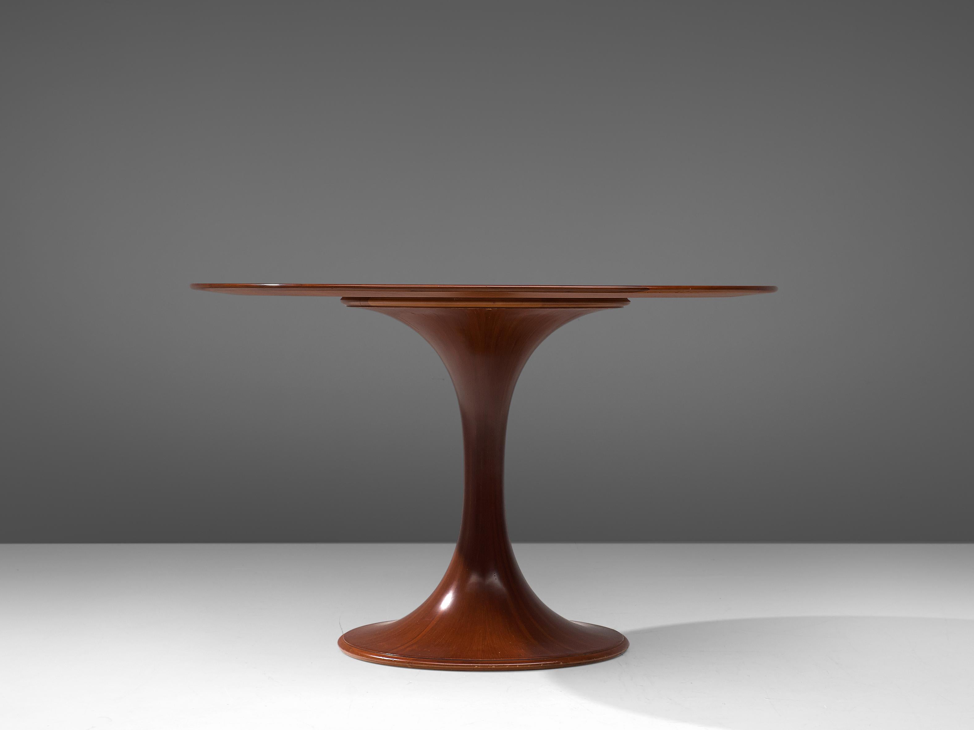 Luigi Massoni, dining table, model 2101, walnut, Italy, 1950s. 

Round pedestal dining table by Italian designer Luigi Massoni. Beautiful detailed pedestal feet, with excellent woodwork which creates a beautiful layered expression. The round walnut