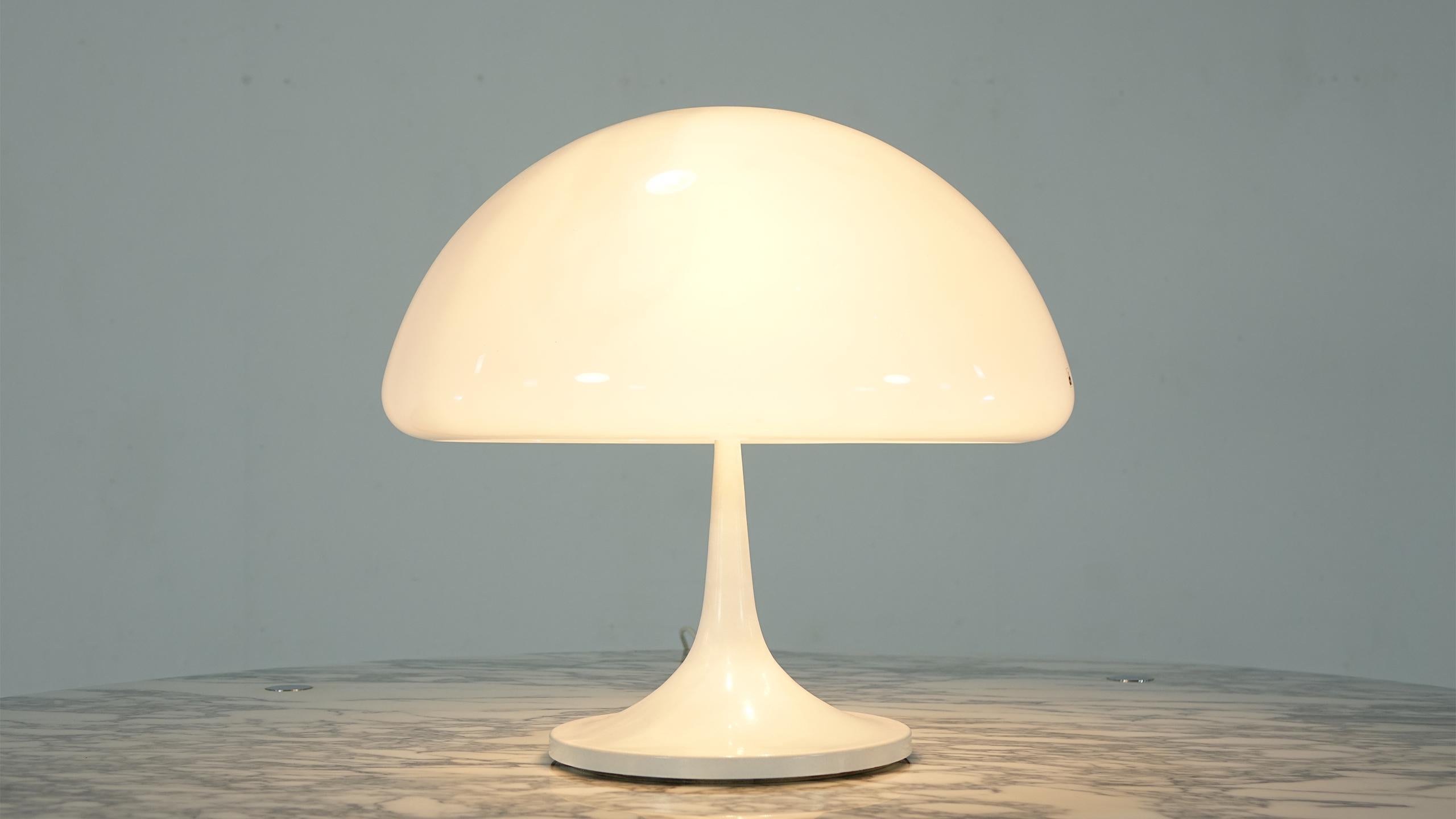 Designed by Luigi Massoni, circa 1968 for Harvey Guzzini with a off white metal base and lampshade made of white methacrylate.
This is the first version (the base of the lamp still consists of one part and is not as high; the base of the later
