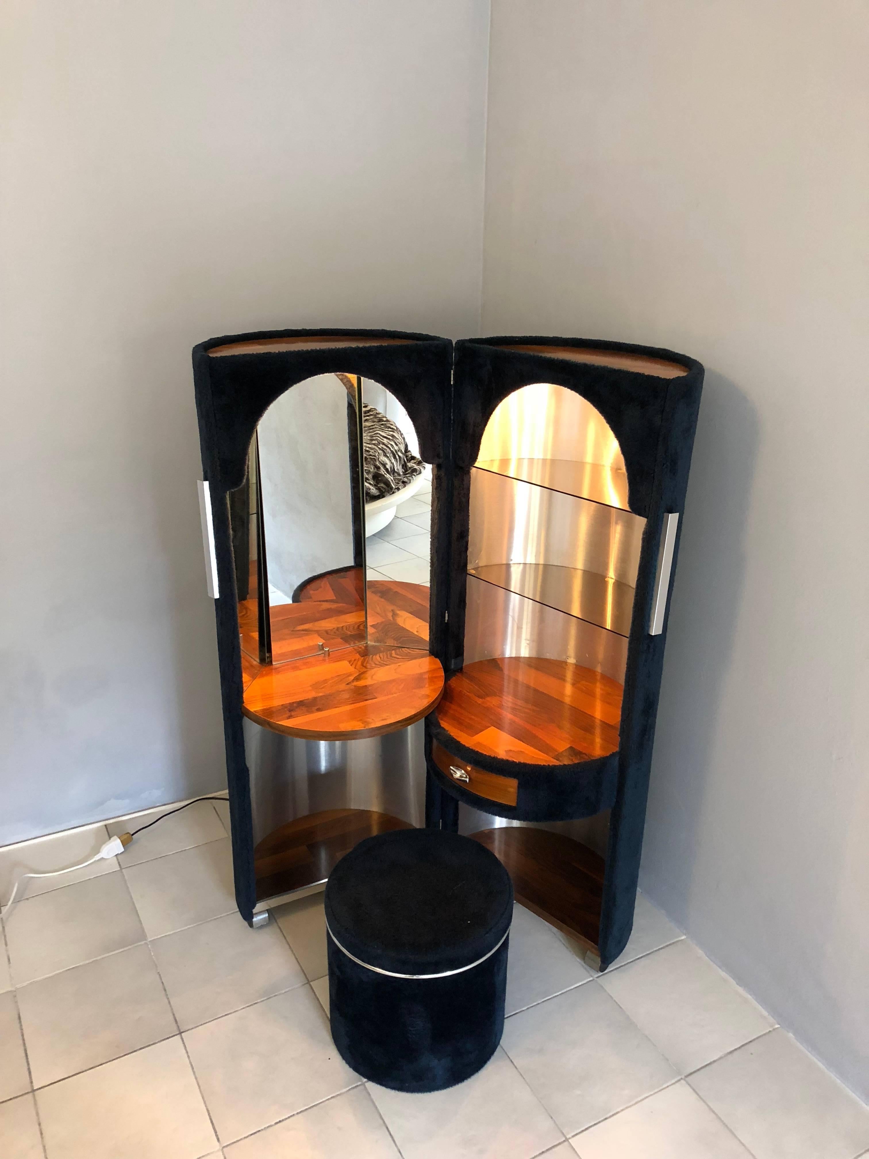 Wonderful Poltrona Frau blue faux fur dressing table designed by Luigi Massoni in the 1970s. It features a cylindrical shape that folds out in two split cylinders lined with synthetic blue faux fur on wheels and a retractable stool inside the shape