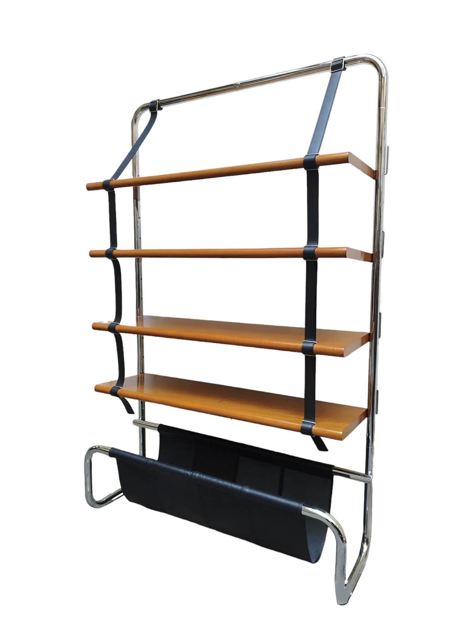 Beautiful Jumbo wall unit designed by Luigi Massoni for Poltrona Frau, Italy 1971. Chromed tubular steel frame with wood shelves suspended by black leather straps. At the base there is a black saddle leather pouch - perfect for holding magazines.
