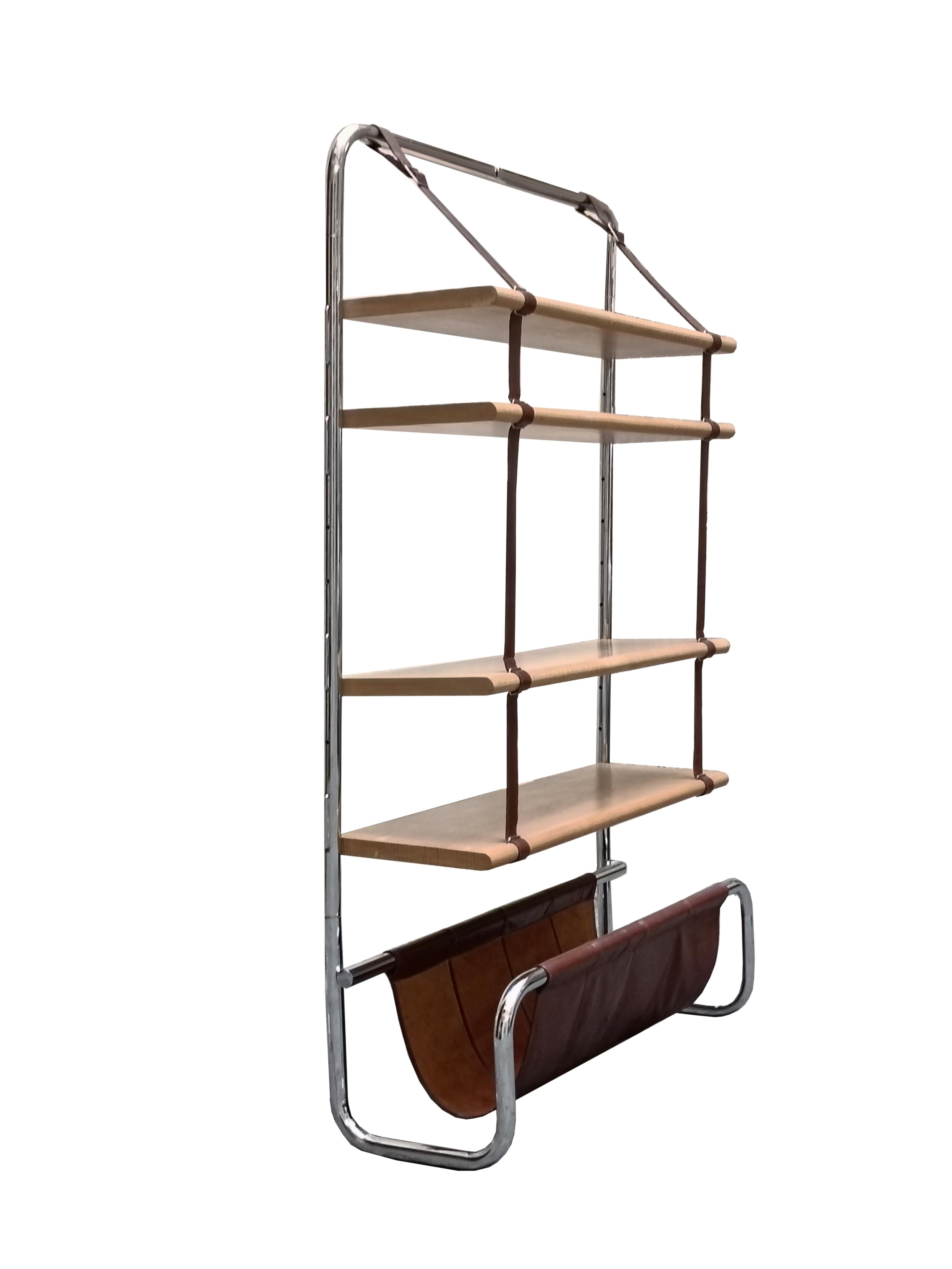 Beautiful Jumbo wall unit designed by Luigi Massoni for Poltrona Frau, Italy 1971. Chrome-plated tubular steel frame with natural wood shelves suspended by natural leather straps. At the base is a natural leather magazine rack. The wall unit can be