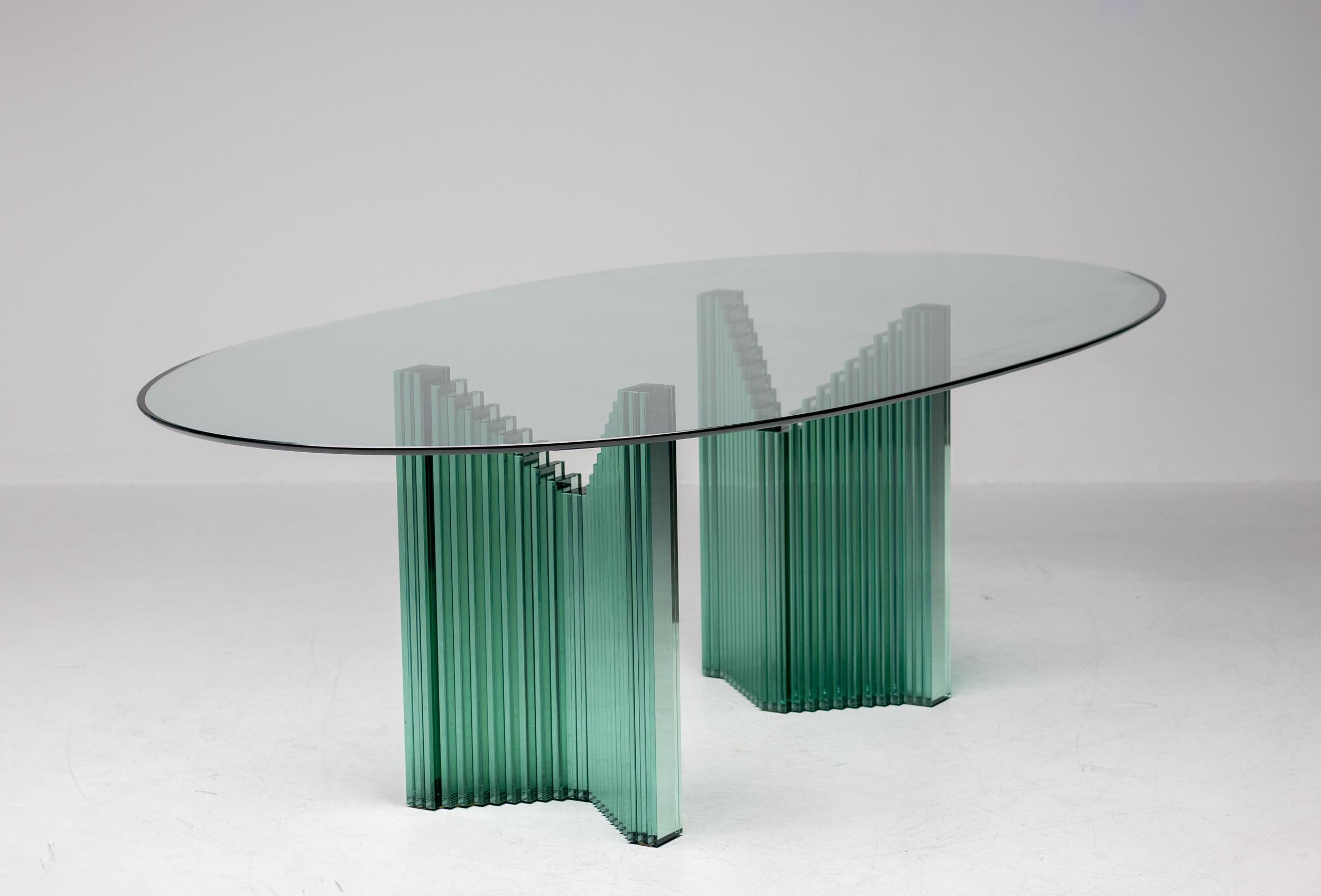 Versatile oval all glass table designed circa 1980 by Luigi Massoni for Gallotti & Radice.
Useable as a desk or a conference table depending on how the 2 glass bases are placed underneath the top.
Placed inside out it is a very impressive large