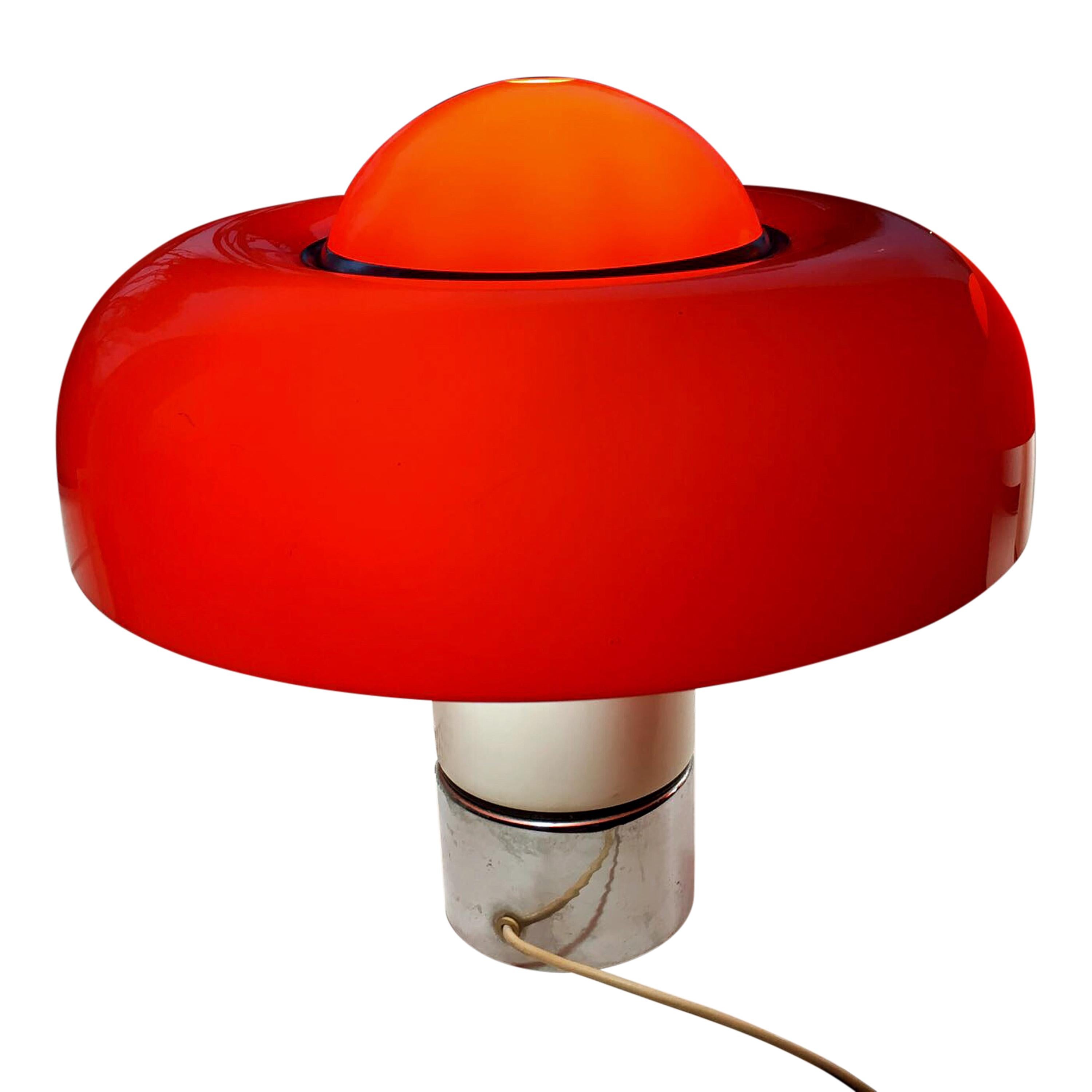 Pair of “Brumbury” table lamps designed by Luigi Massoni, manufactured in 1969 by Harvey Guzzini, Italy. Heavy foot of metal (white varnish and chrome-plated), the shade is made of orange opal acrylic.
One of the two lamps shows a slight bump of