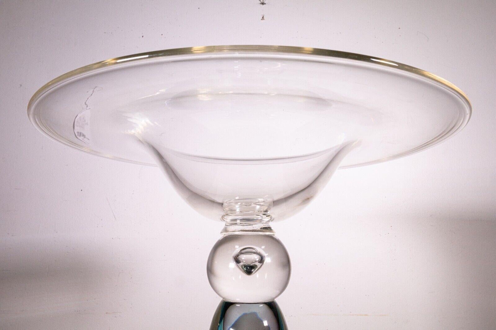 A Luigi Mellara large glass bowl centerpiece. This wonderful glass sculpture centerpiece bowl features a mix of clear glass and colored blue glass detailing. This piece stands very elegantly and looks lovely as a centerpiece. It is hand signed on