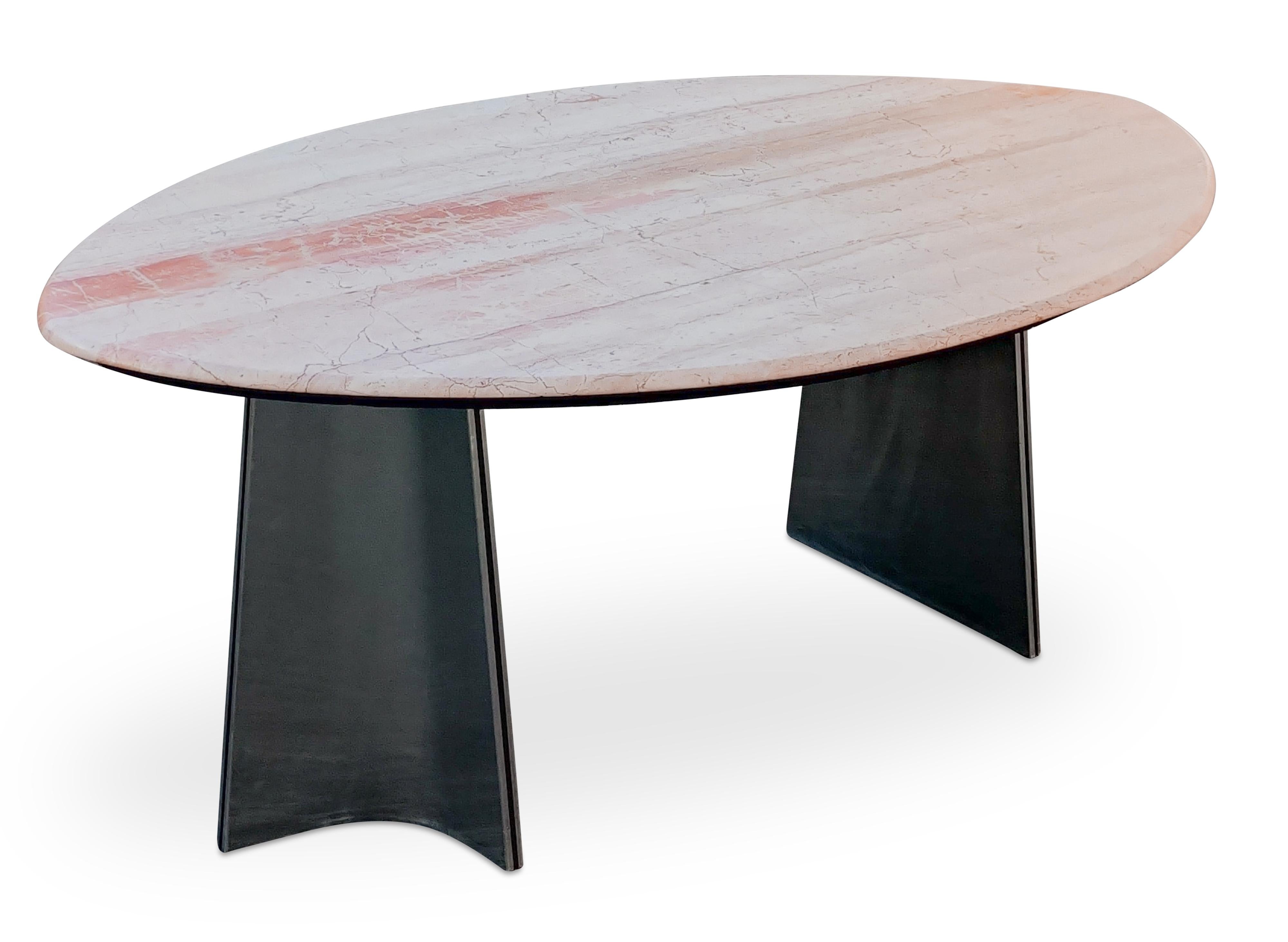 What distinguishes this table from all the other Luigi Saccardo for Arrmet dining table offerings is this fabulous large sharp-oval pink marble top! We say sharp-oval becuase of the elongated ends and the bullnosed edge treatment. Also prominent are