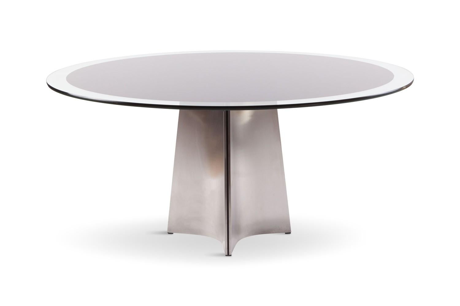 This extravagant contemporary dining table is perfect in every way, and. Curved in toward the table's center, this iconic piece by Italian Modernist Luigi Saccardo for French firm Maison Jansen in the 1970s is made from concave bendable sleek