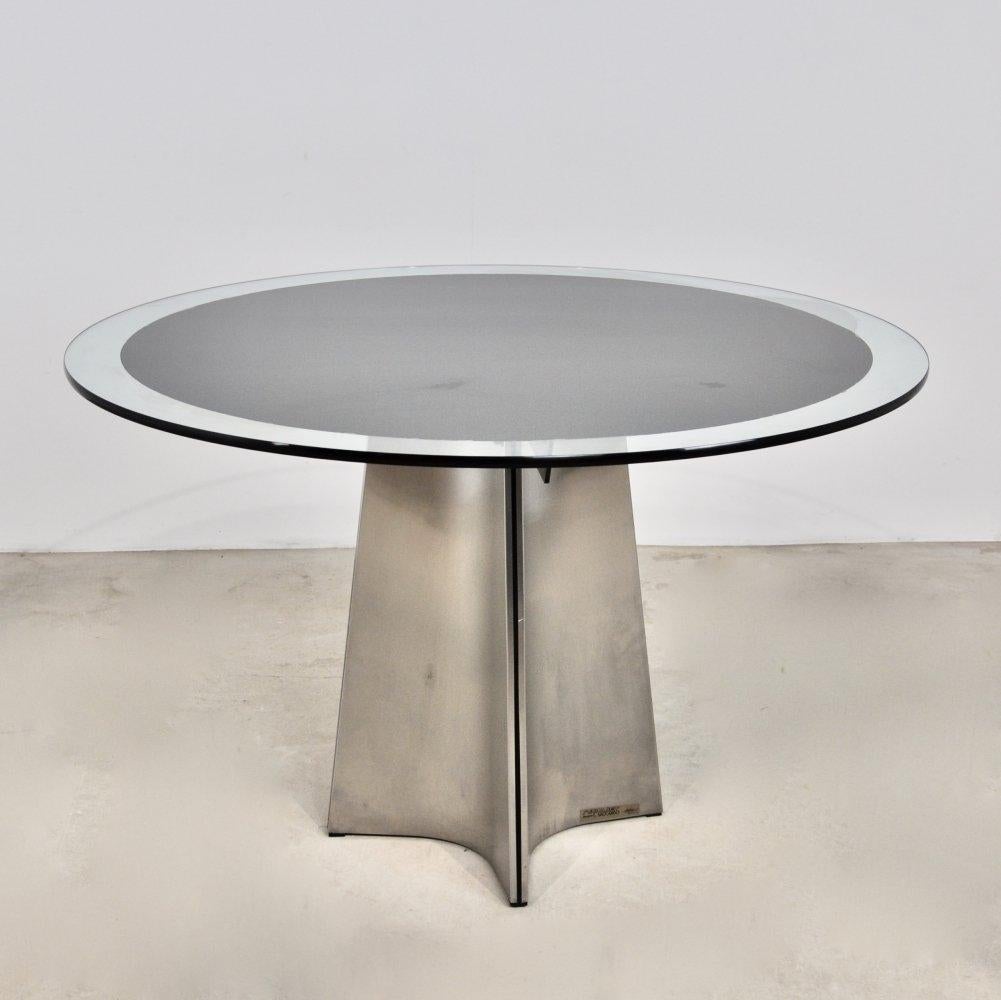 Dining table with circular glass top, 130 cm diameter, brushed aluminum base, signed Luigi Saccardo produced by Arrmet, Italy around 1970 Fair condition.  More photos on demand 