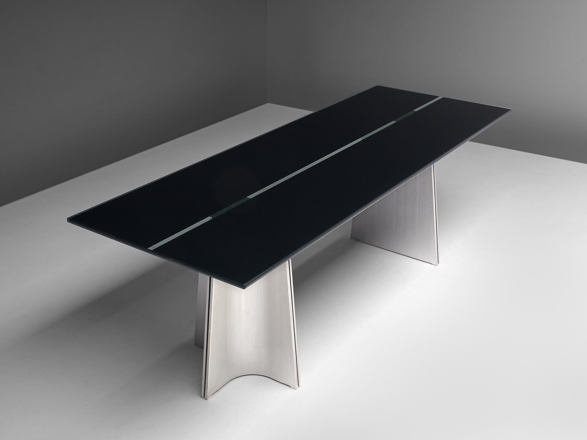 Luigi Saccardo, dining table model 'Ufo', metal and glass, Italy, 1970s

Sculptural Postmodern dining table or desk, named Ufo, by Luigi Saccardo
The base consists of two legs which are formed of two concave curved plates of metal and one