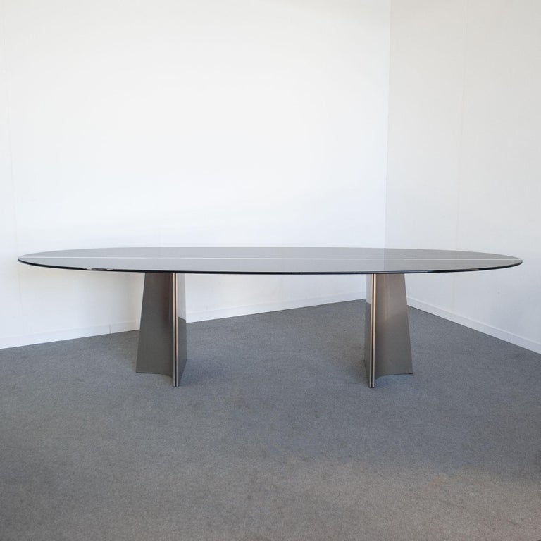 Superb generously sized table, smoked glass top, curved aluminum feet, designed by Luigi Saccardo for Armet in the mid-70s.