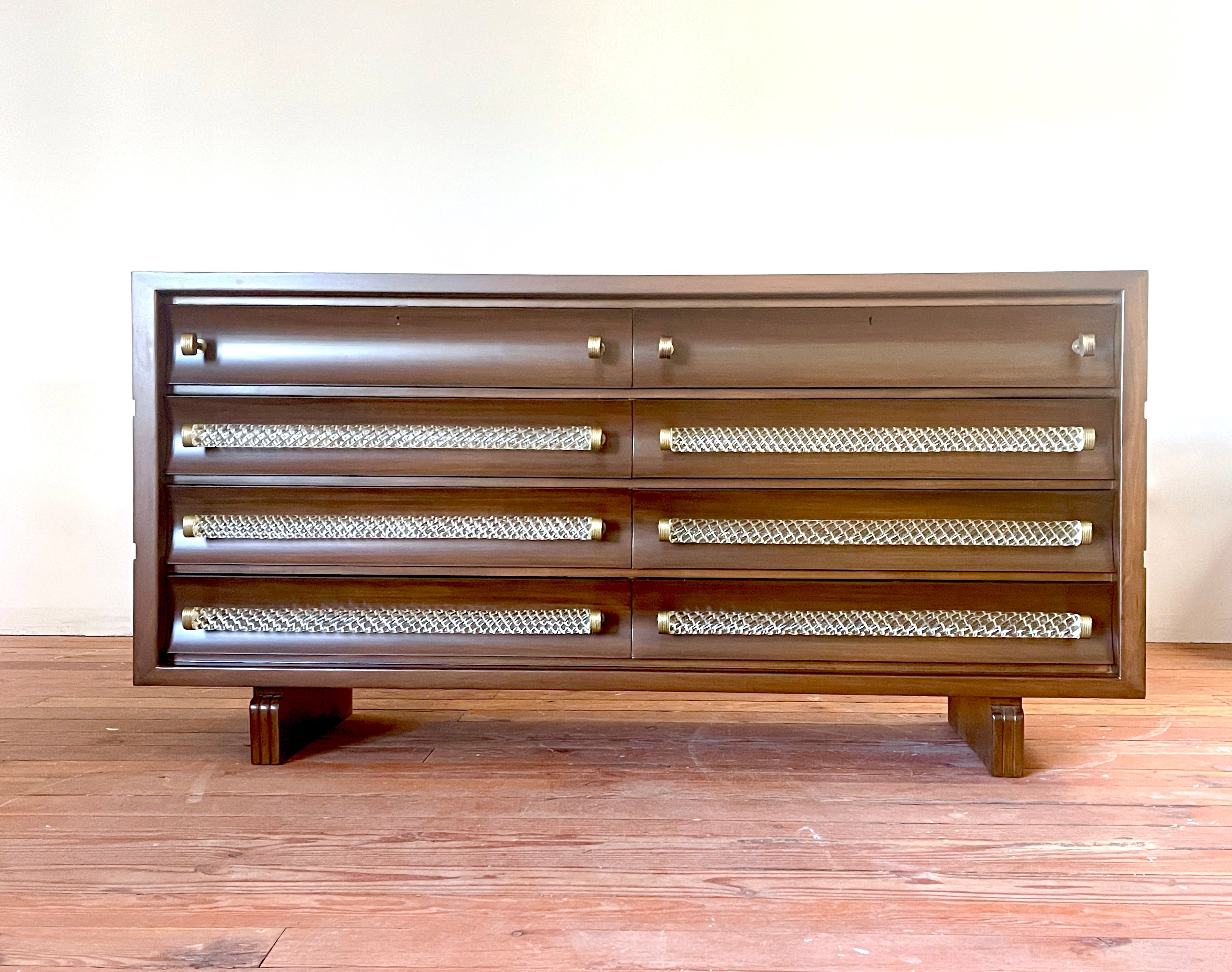 Stunning 1940's Italian chest of drawers designed by Gio Ponti, manufactured by Luigi Scremin.
Murano twisted solid glass handles and thick ornate brass hardware. 
Carved edges and cubist sides newly refinished. 
Total of 8 drawers / original key
