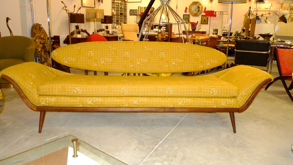 Strikingly sculptural vintage early 1960s gondola sofa with floating surfboard upholstered back designed by Luigi Tiengo for Cimon Ltée of Montreal in 1964. Loose seat cushion. Walnut frame. Tapered splayed walnut legs. Visually impactful from all