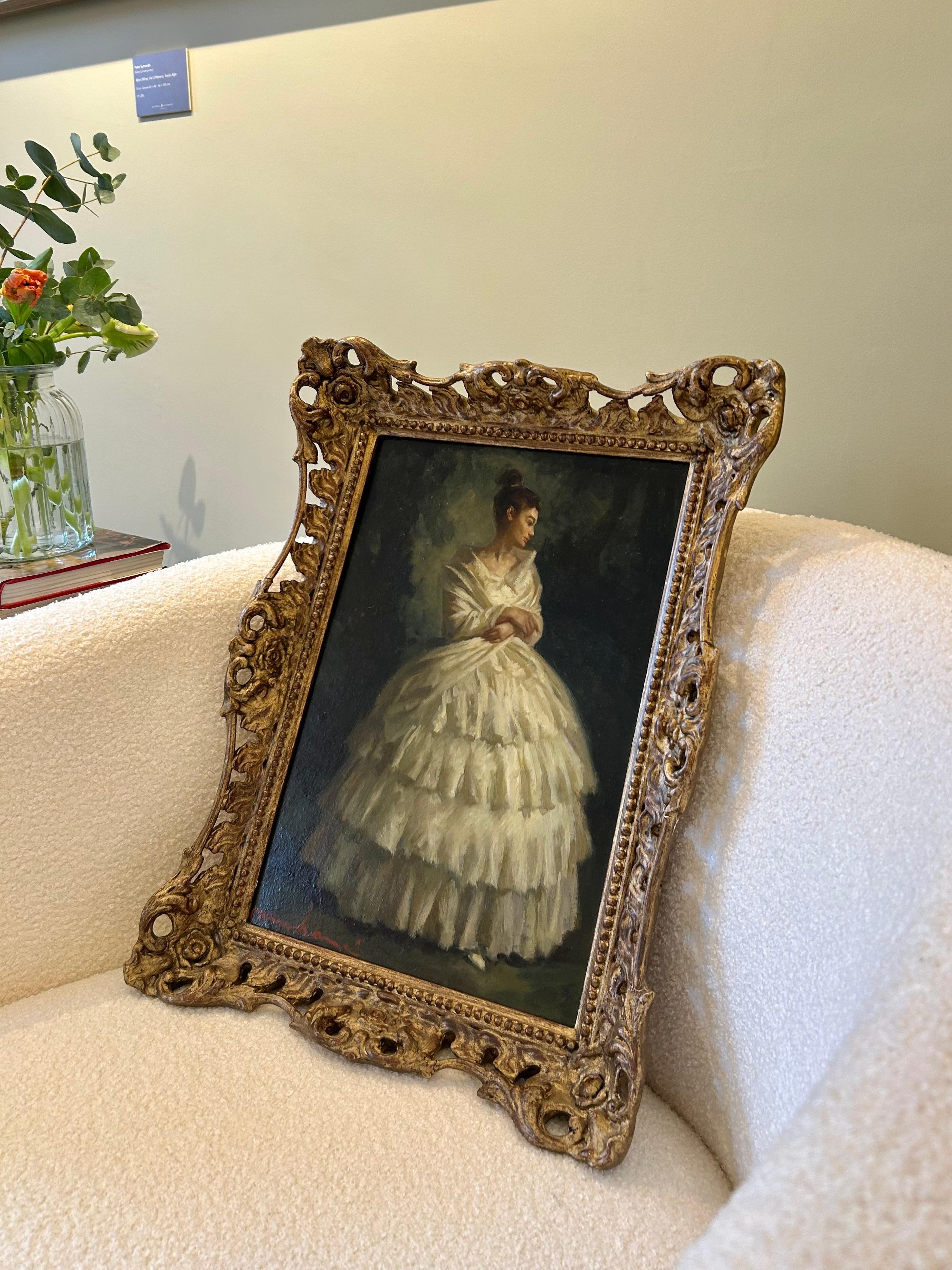 This captivating oil painting by Luís Muntané Muns exemplifies the artist’s mastery in figurative art, portraiture, and classical elegance. Renowned for his evocative depictions of finely dressed women, Muns presents a young woman in an opulent,