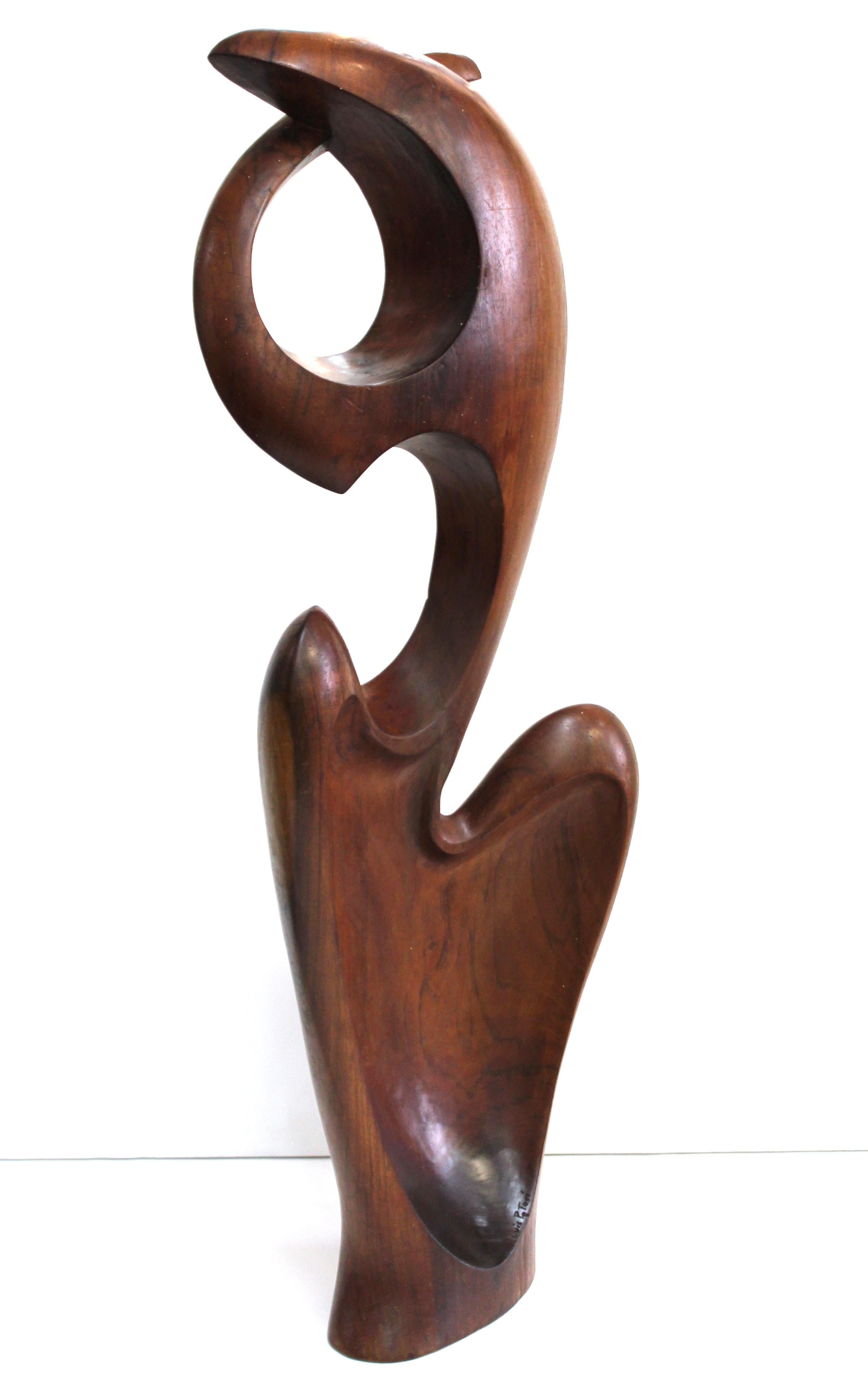 Ecuadorian Modernist abstract sculpture in carved wood, created by Luis Potosi during the mid- late 20th century. The piece depicts an abstract biomorphic shape and is signed 'Luis Potosi' on the inner lip of the carved base. In great vintage