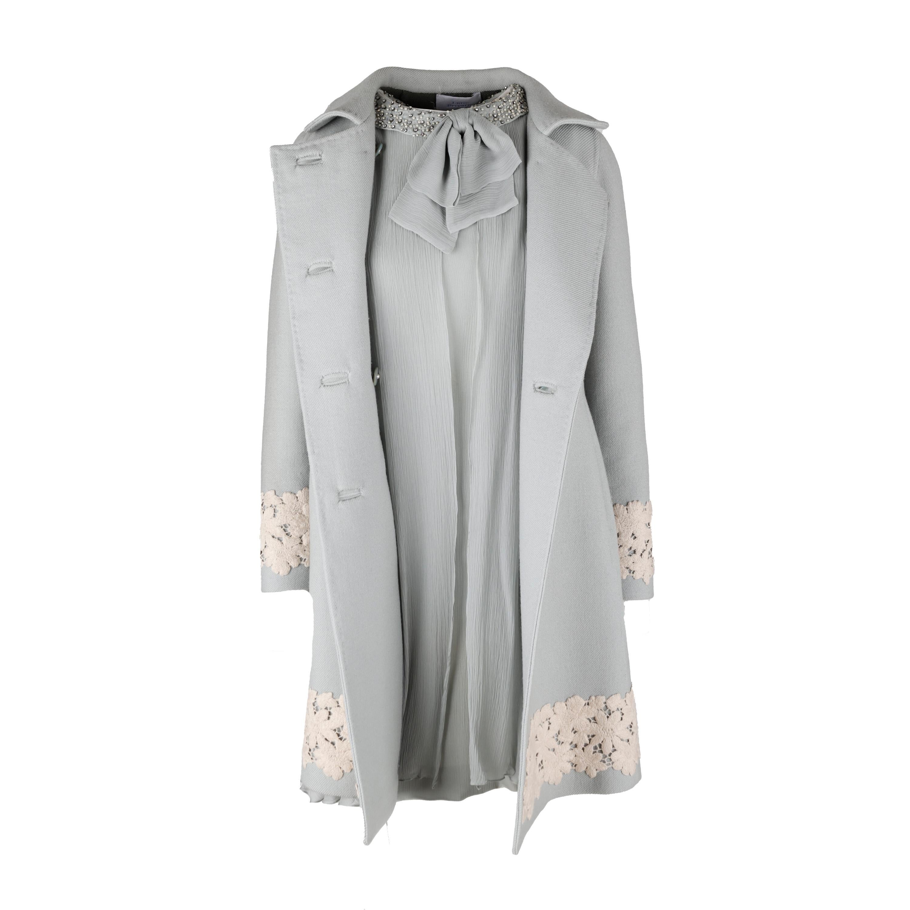 This Luisa Beccaria dress and coat set is crafted with quality in mind. In a soft powder blue, the fitted wool coat features a double-breasted silhouette with buttons in the front and white embroideries at the hem as a luxe detail. The sleeveless