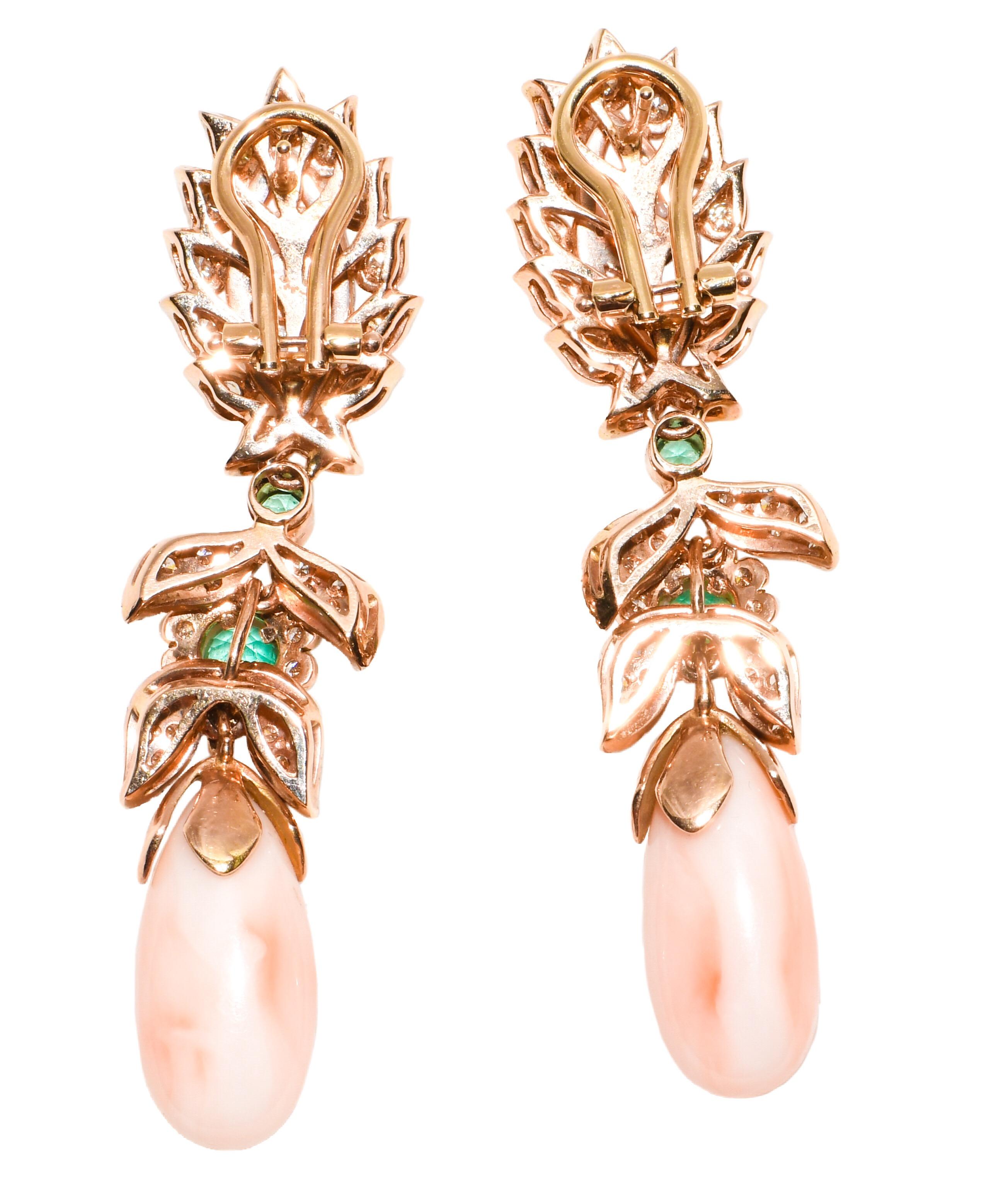 Fabricated in 14 karat yellow gold, these Italian beauties are unmistakably Luise Gioielli.  Marquise shape angel skin coral tops are framed in white diamonds.  Dangling effortlessly is a bezel set round emerald followed by more diamonds and another