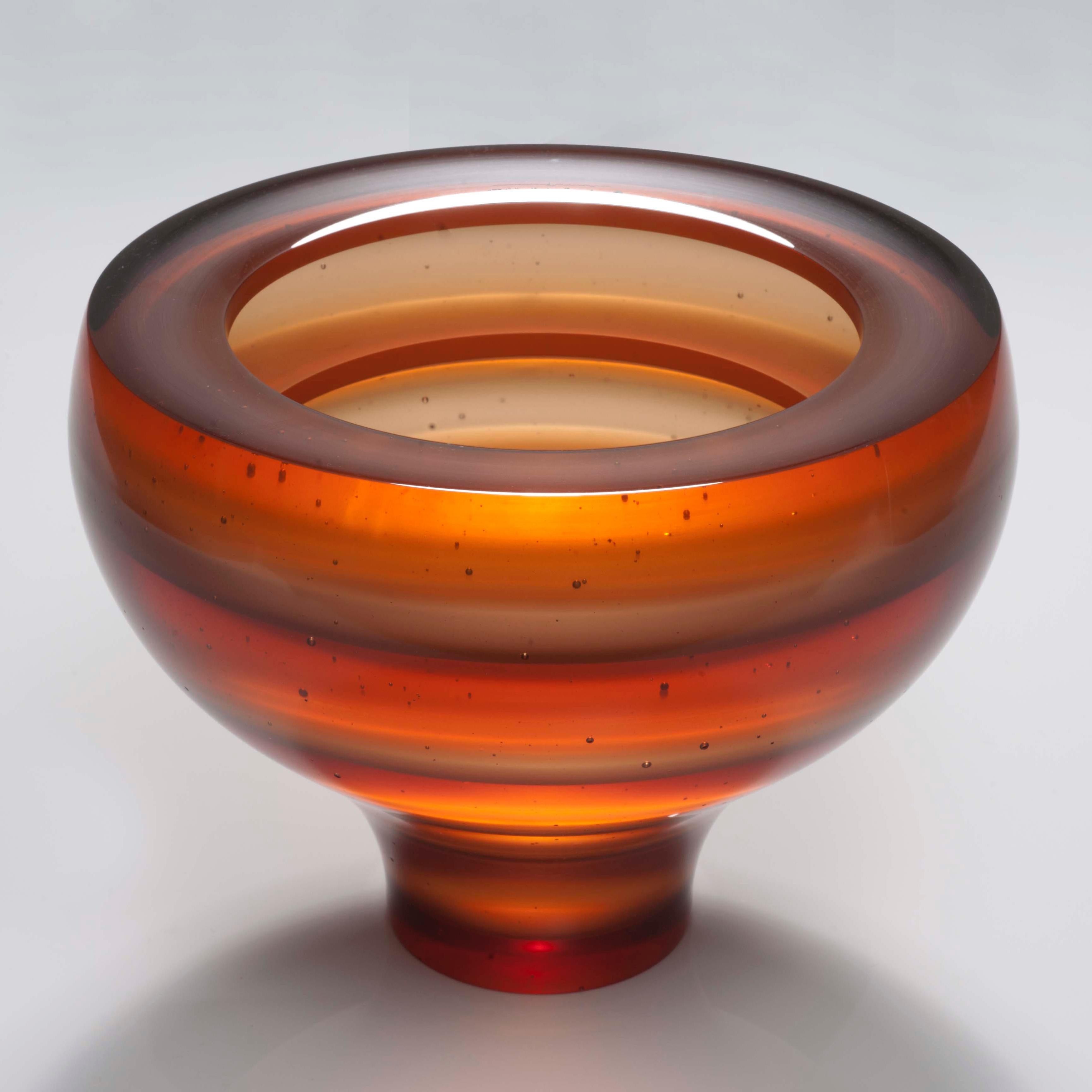 Luka is a cast glass artwork in a beautiful soft amber / orange by the British artist Paul Stopler. With a smooth exterior, the interior is stepped into five sections by four ridged protruding 