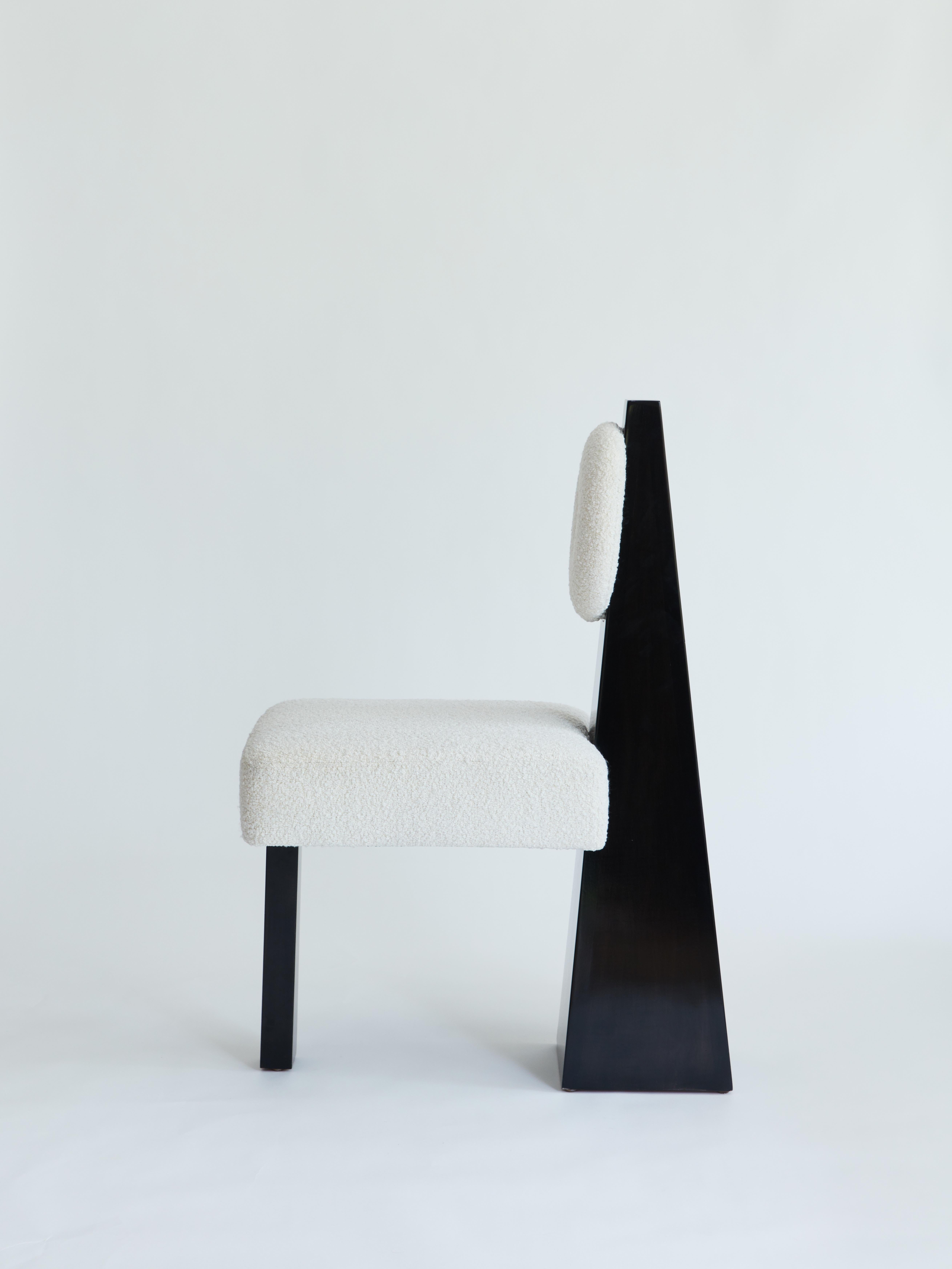 Made to order bouclé and wood chair designed by Christian Siriano.

Base: Black Lacquered Maple

Fabric for seat/back cushion: 
Ivory Bouclé

Overall Depth: 28”
Overall Height: 40”

Seat Depth: 21”
Seat Height: 20”
Seat Width: 19”.
 