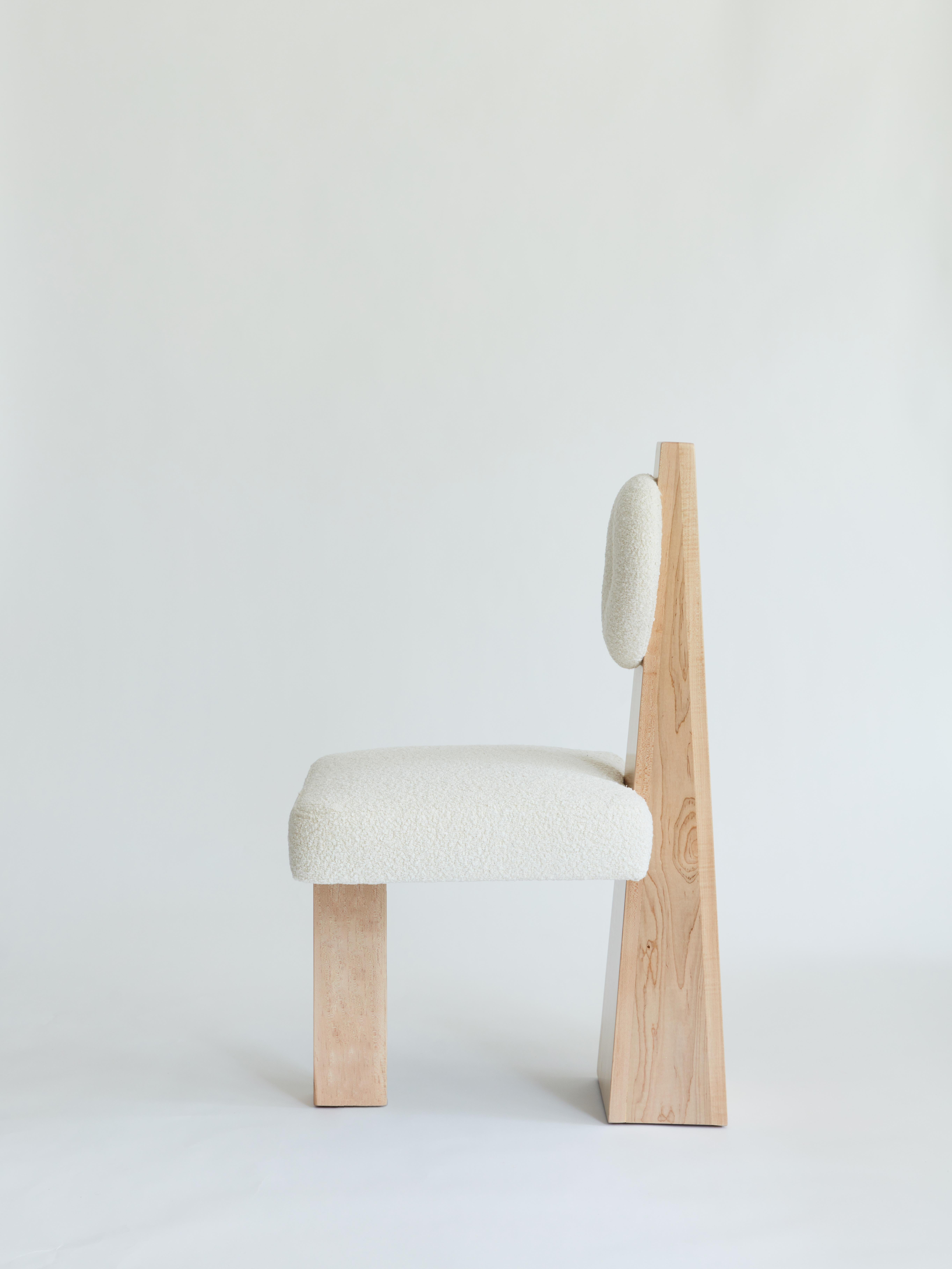 Made to order bouclé and wood chair designed by Christian Siriano.

Base: Natural Maple

Fabric for seat/back cushion: 
Ivory Bouclé

Measures: Overall depth: 28”
Overall height: 40”

Seat depth: 21”
Seat height: 20”
Seat width: