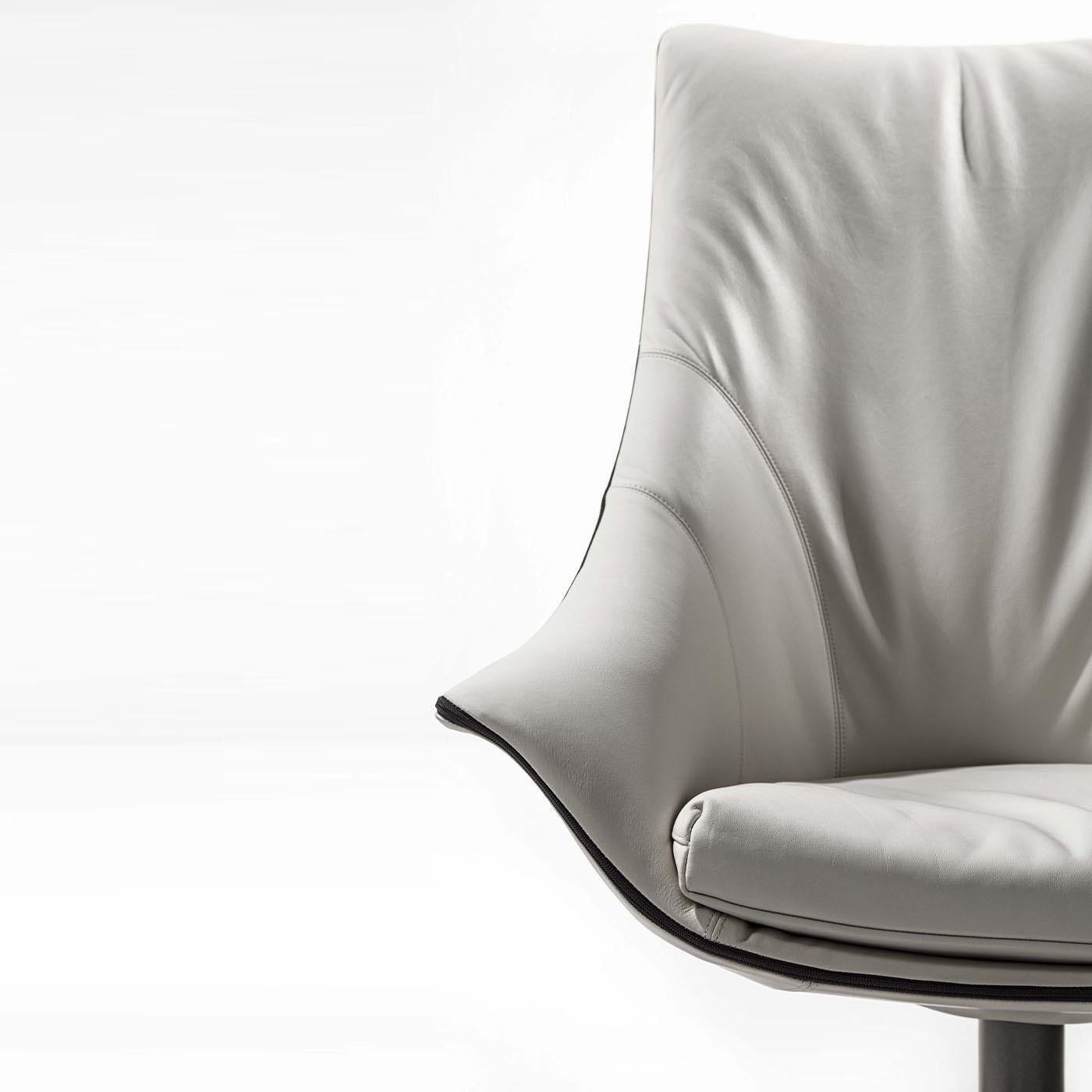 Prioritizing comfort without compromising on comfort, this armchair is the epitome of modern elegance. Sporting an all-white look, the polyurethane shell with a tall back and slightly flared armrests is supported by a 4-star fixed base and