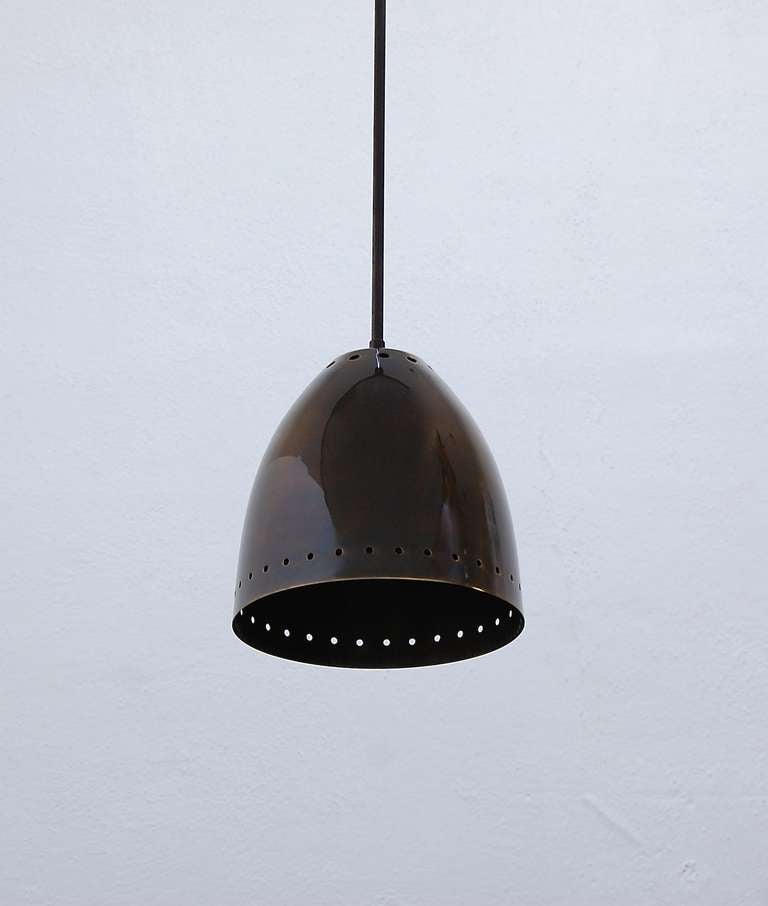 The Lulled Pendant is an elegant brass patinated pendant with perforated shades.
The drop can be adjusted upon request.
Shade dimensions: 9 H x 8.25