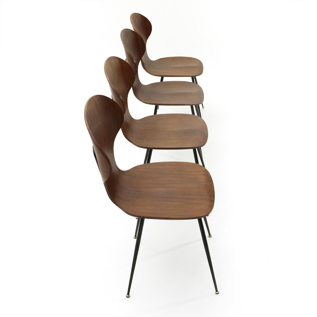 Four chairs produced by Industria Legni Curvati in the 1950s based on a project by Carlo Ratti.
Black painted metal structure. Hot curved plywood shell.
Good general conditions, some signs due to normal use over time.

Dimensions: Width 44 cm,