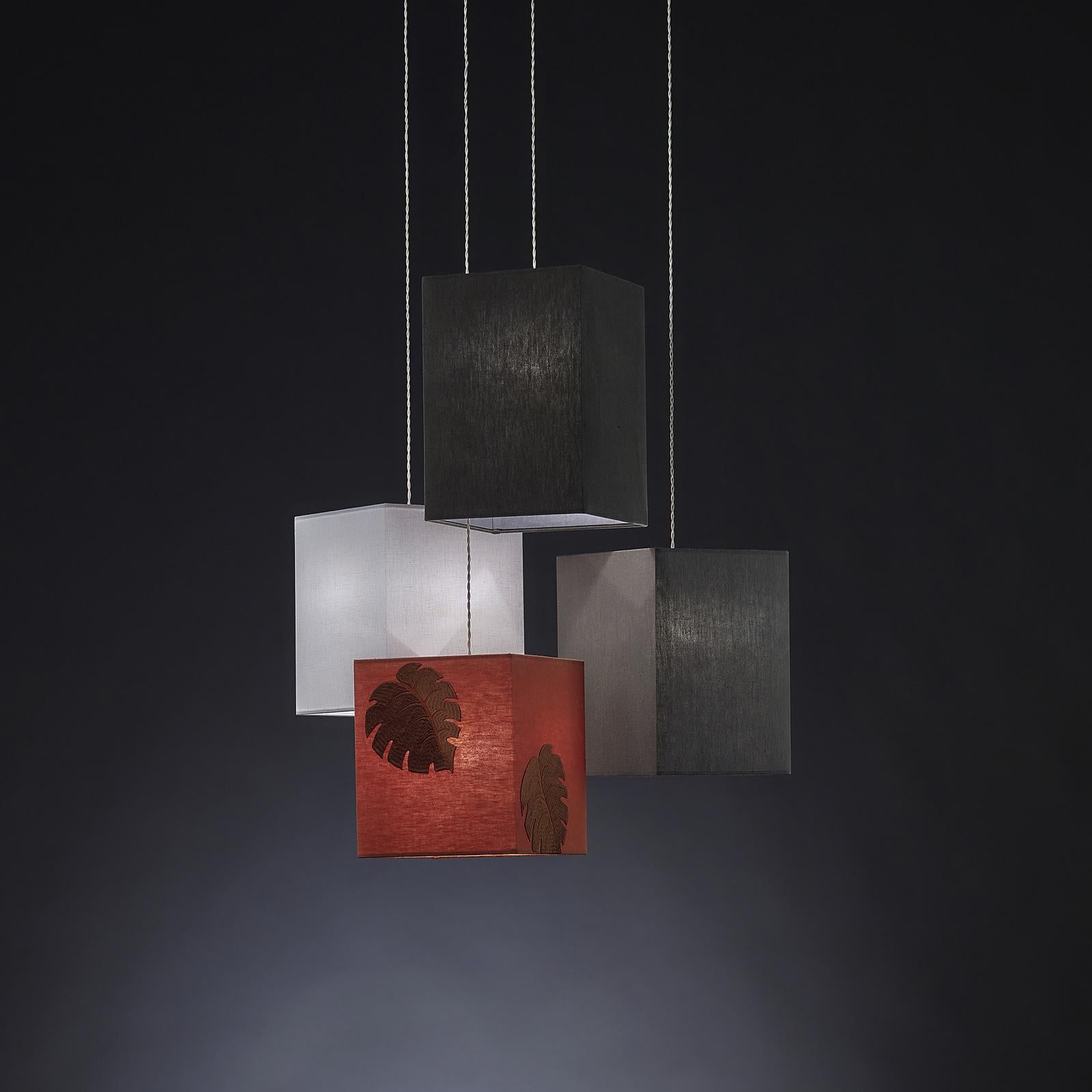 A captivating use of chiaroscuro with a contemporary touch, this exceptional arrangement of bespoke pendant lamps will heighten the drama of any Minimalist loft decor. The square lampshades are handcrafted of stonewashed linen and measure (in cm.):