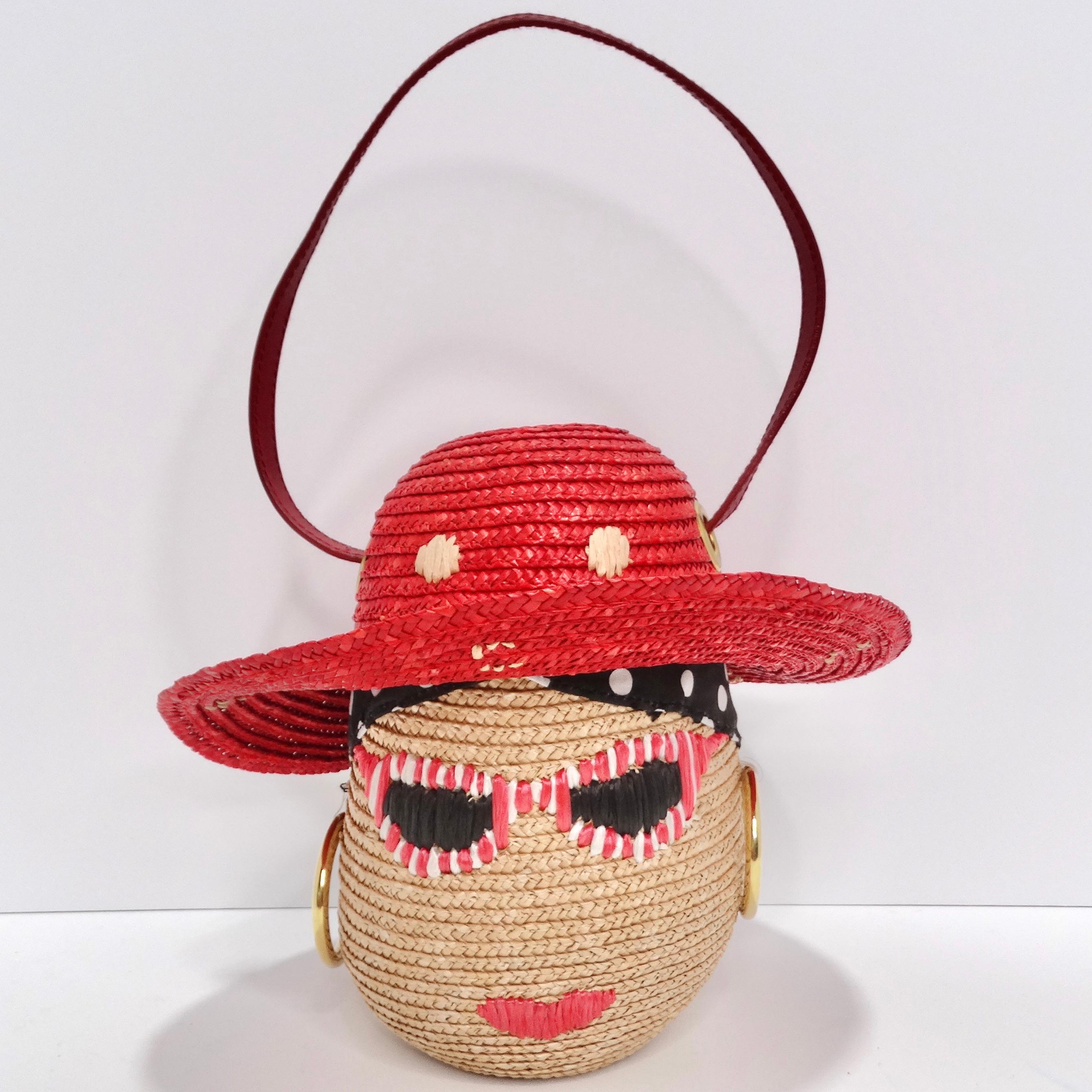 Elevate your style with this Lulu Guinness Face Motif Raffia Woven Basket circa 1990s! This adorable mini top handle handbag is a true fashion gem, featuring an eye-catching face motif that includes red and white sunglasses, gold-tone hoop earrings,