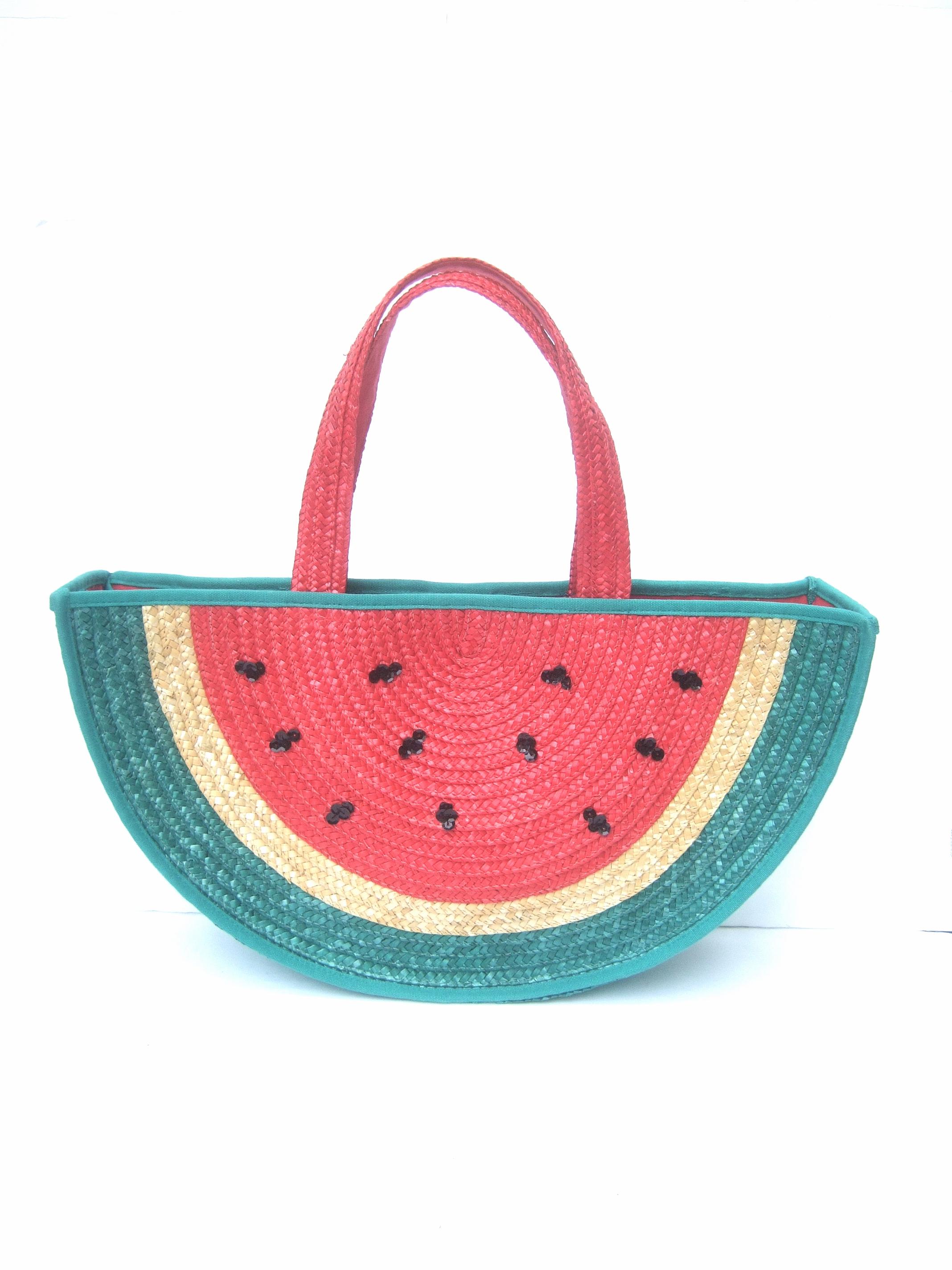 Lulu Guinness London Whimsical straw watermelon tote-handbag 
The fun summer large scale tote style handbag is designed
with red and green panels of woven straw in the shape
of a watermelon

Accented with clusters of black sequins emulating