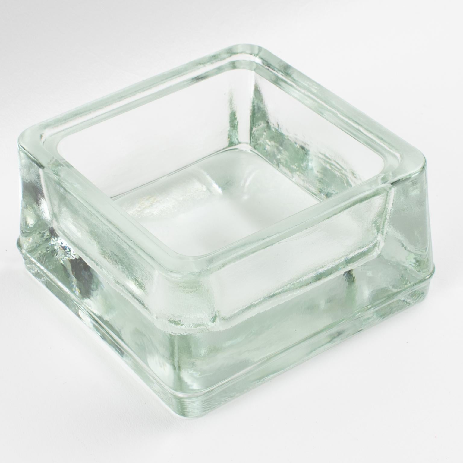 This sturdy industrial thick molded glass desktop accessory, desk tidy, ashtray, or catchall, was manufactured by Lumax, France, on an original design by Le Corbusier.
Measurements: 4.75 in wide (12 cm) x 4.75 in deep (12 cm) x 2.38 in high (6 cm).