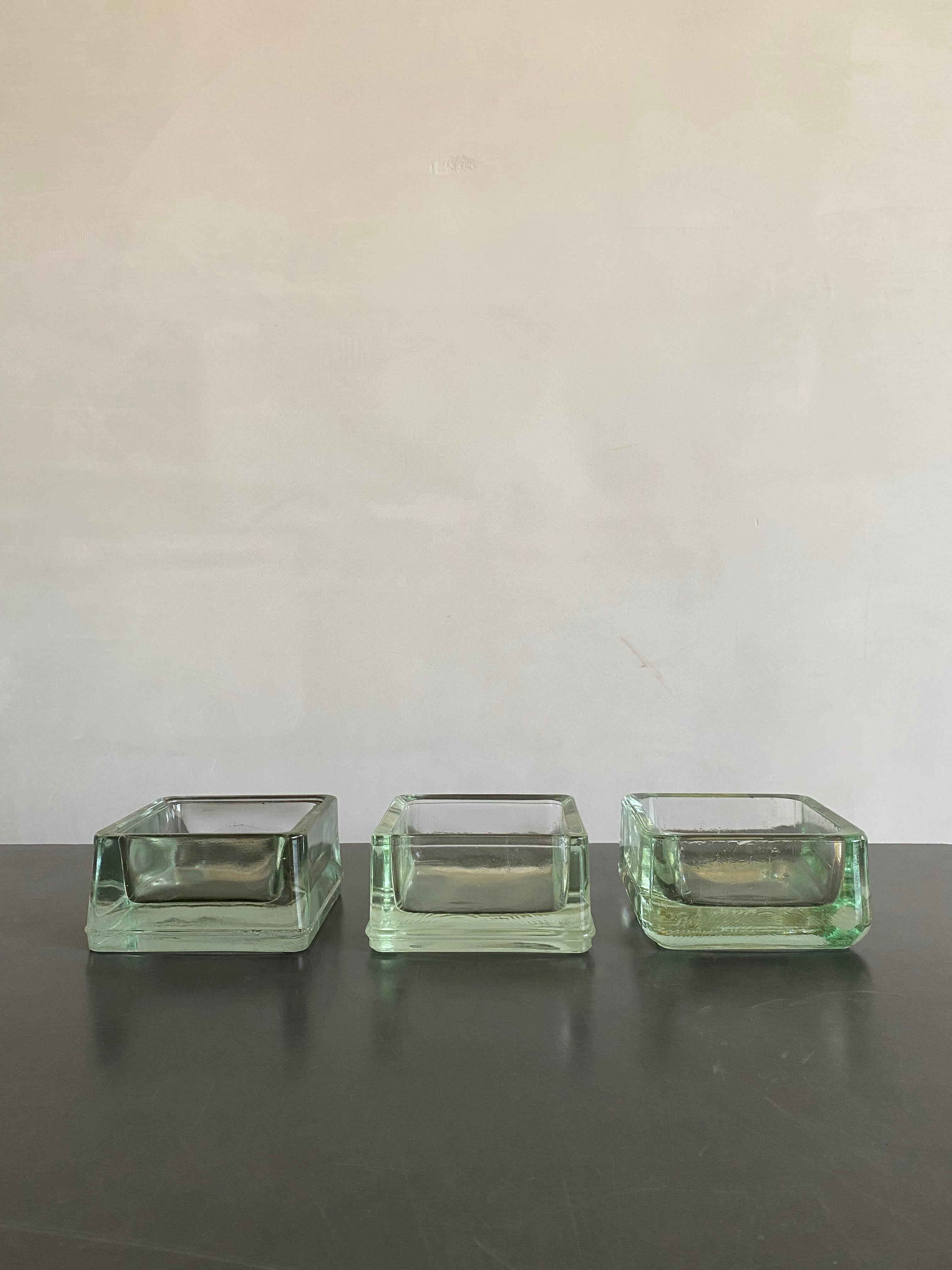 A set of 3 Lumax moulded green glass bowls designed by Le Corbusier.