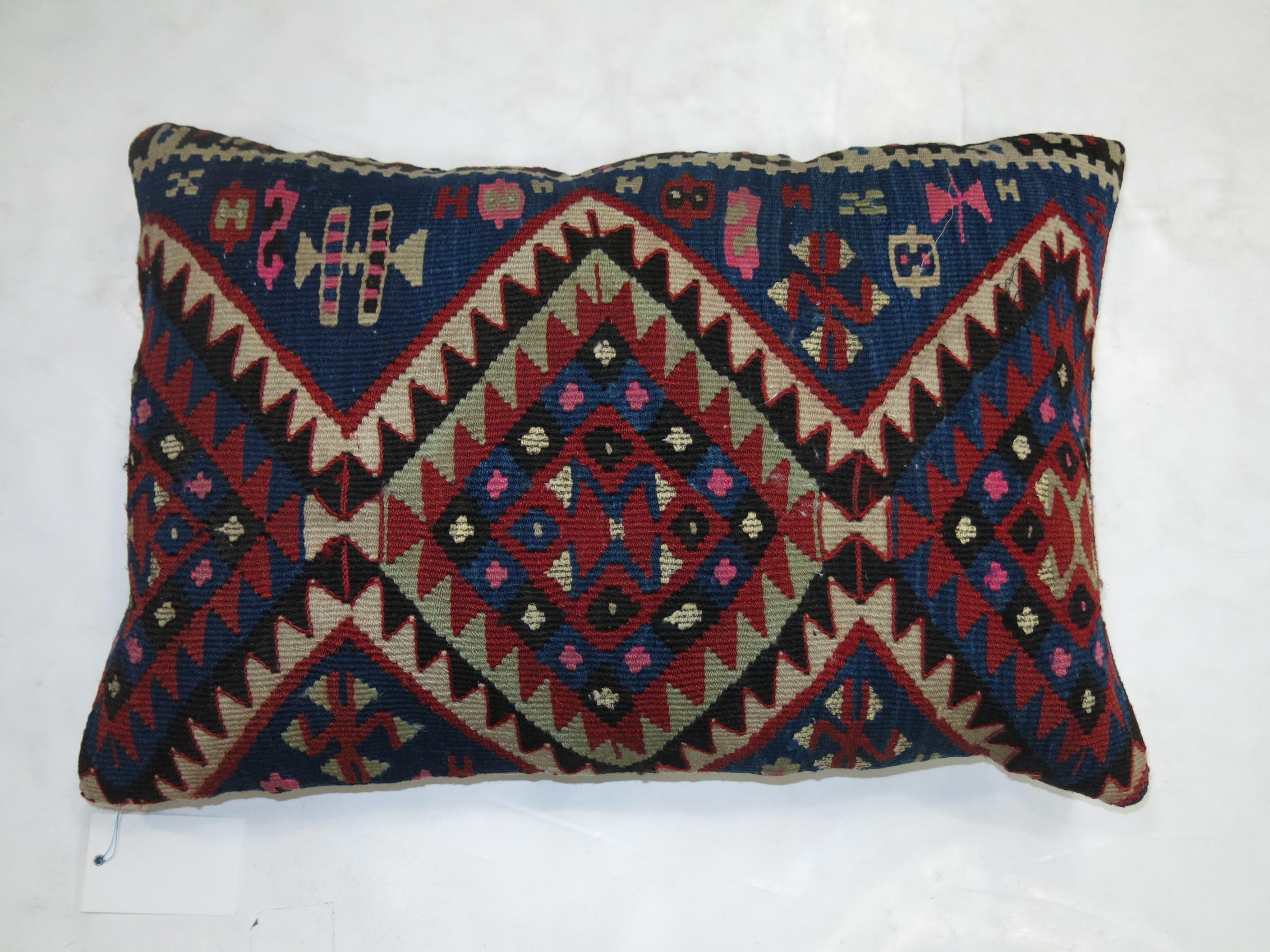 Pillow made from an early 20th-century Persian Kilim.

Measures: 16'' x 24''.
