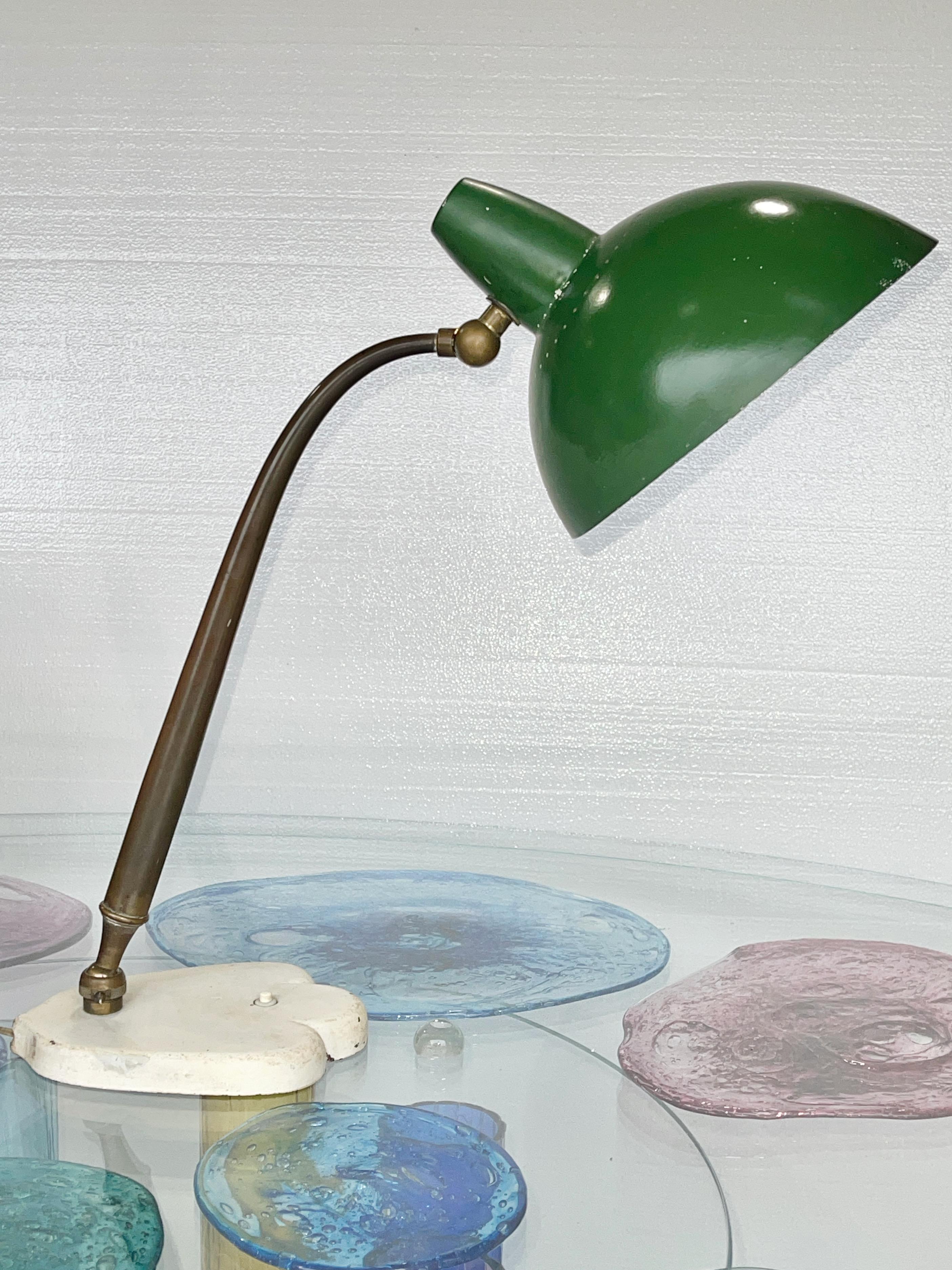 Rare multi-directional table lamp by Lumen Milano, probably designed by Oscar Torlasco, mid-1940's.
Gloriously engineered elongated tapered brass stem stretches from a knurled ball joint fitted to a most unusual cast iron paw foot shaped base with