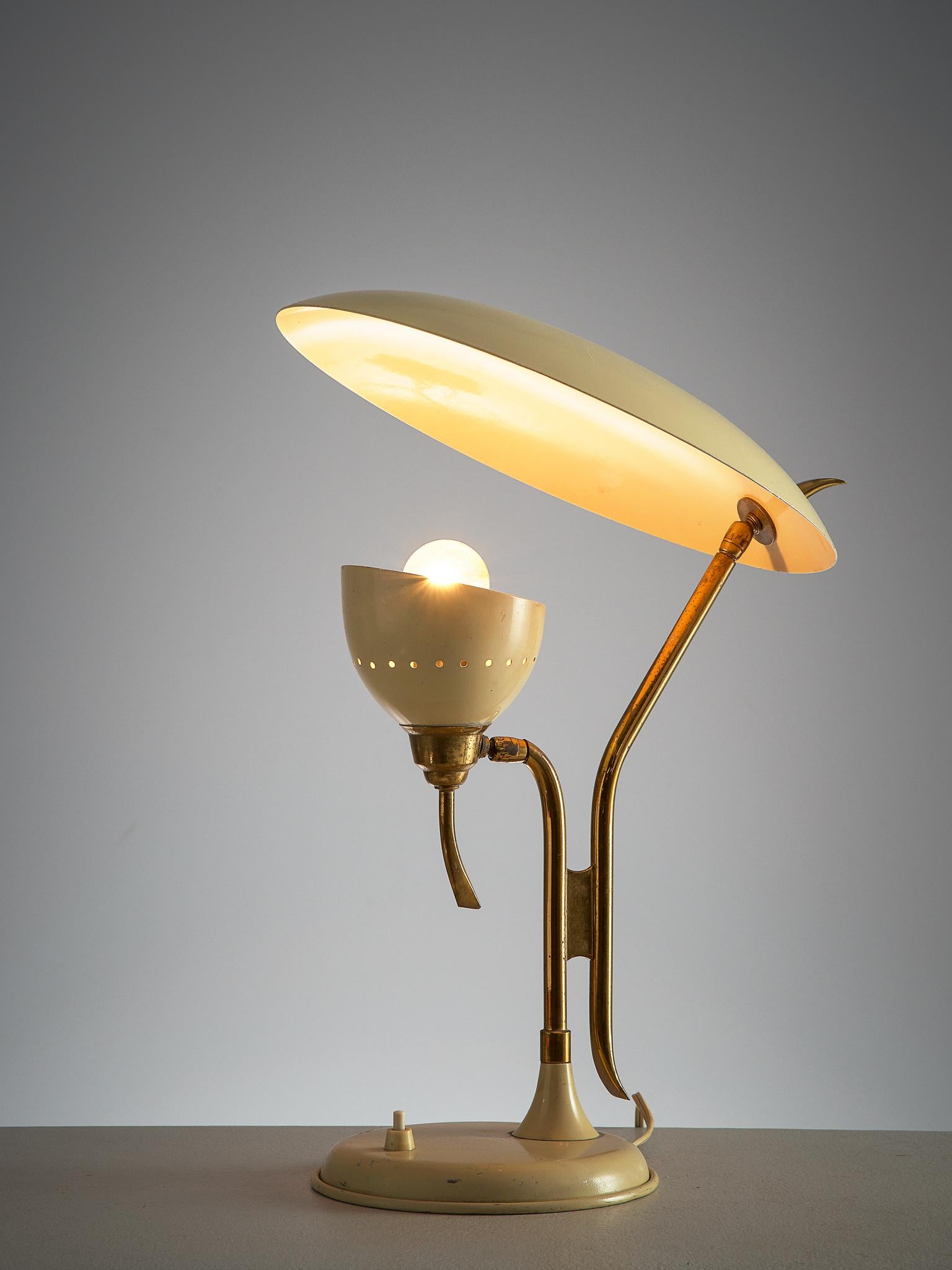 Lumen, table lamp, beige metal and brass, Italy, 1950s.

This 1950s adjustable beige desk light is manufactured by Lumen. The metal shade holding the lamp is directed upwards to another shade. This creates a beautiful diffuse light. Both shades