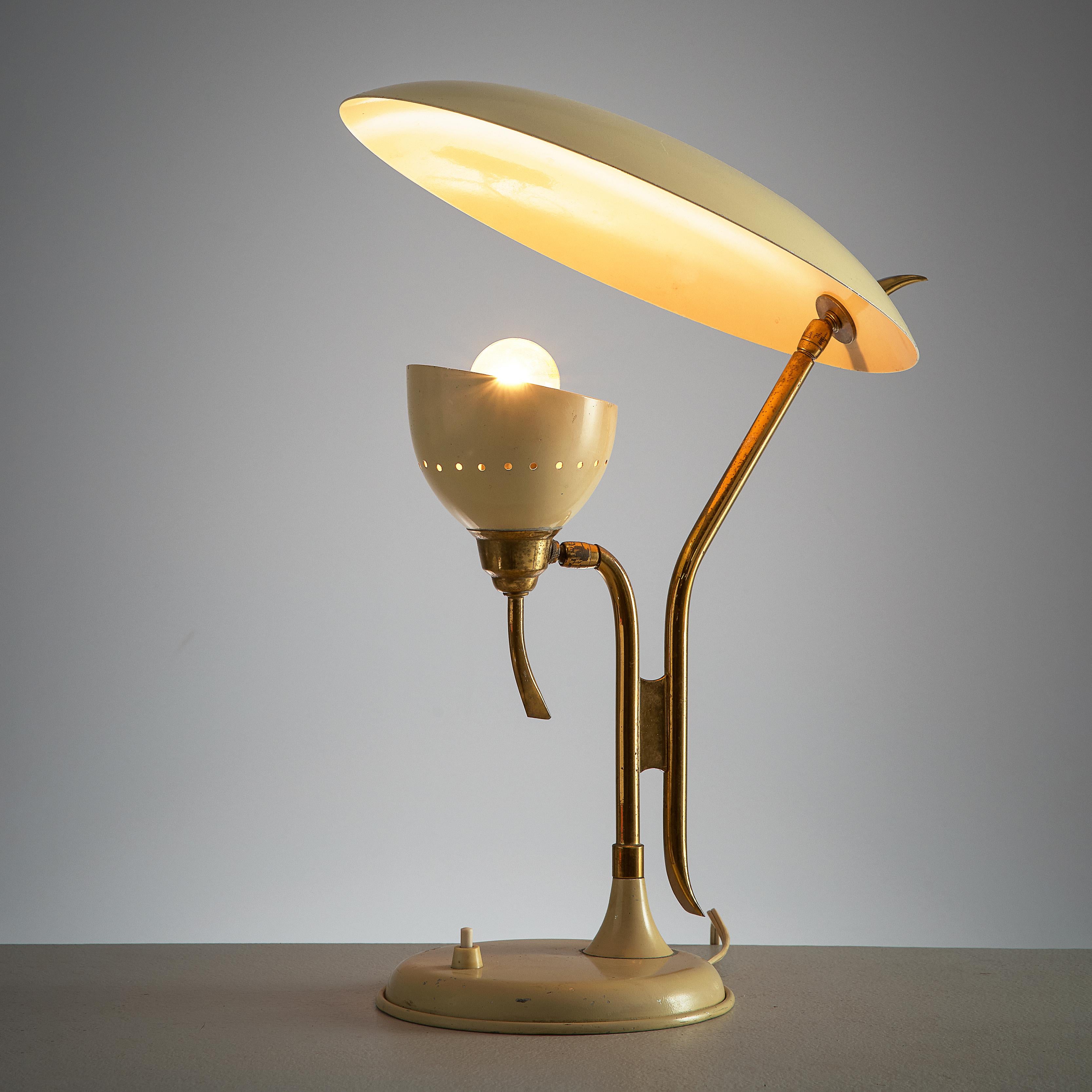 Lumen, table lamp, beige metal, brass, Italy, 1950s.

This 1950s adjustable beige desk light is manufactured by Lumen. The metal stem is holding a small upwards opening shade with a light bulb that directs the light towards the semicircular shade.