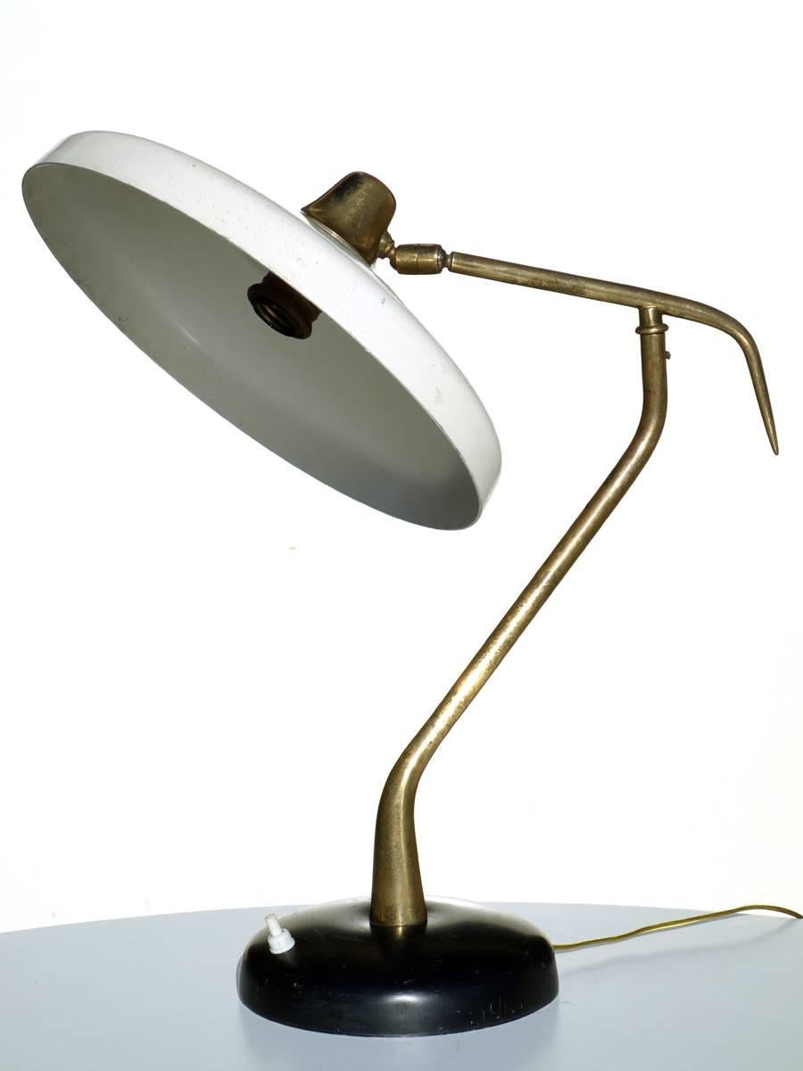 Lumen
Italy, 1950s

Table lamp with adjustable shade
Ivory and black aluminum, brass details.


