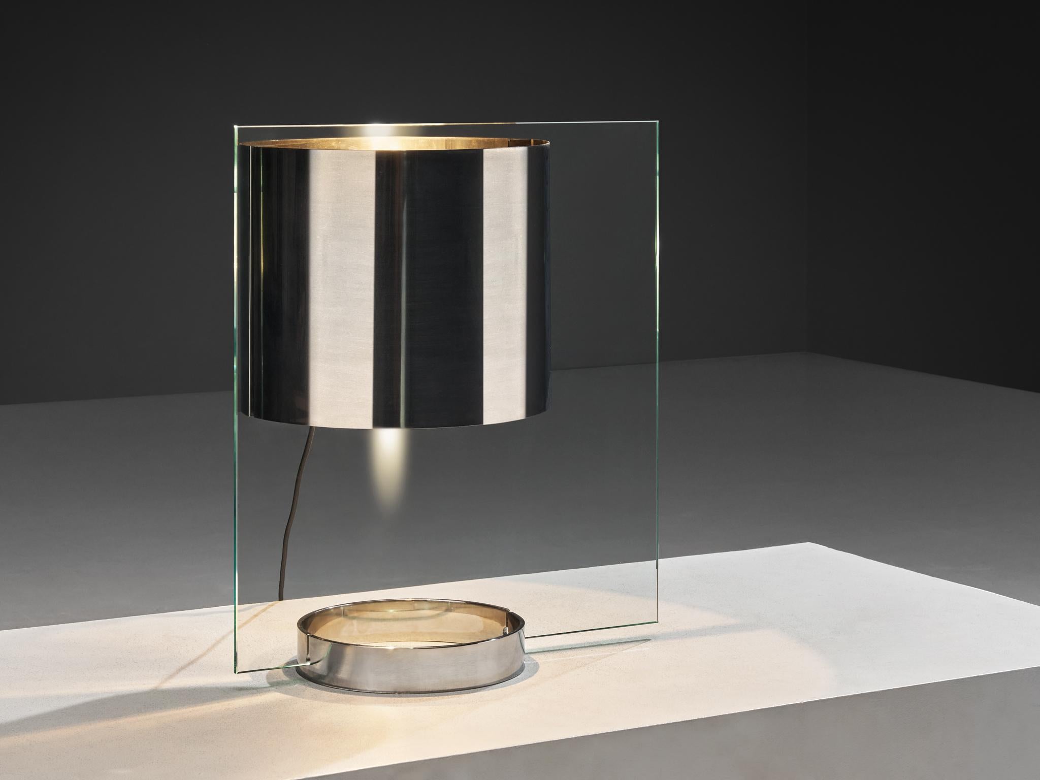 Lumenform table lamp, chrome-plated steel, glass, Italy, 1970s

This striking table lamp, crafted by Lumenform in Italy and stands out as a remarkable piece. Its ingenious design creates the illusion of a floating chrome shade, achieved through a